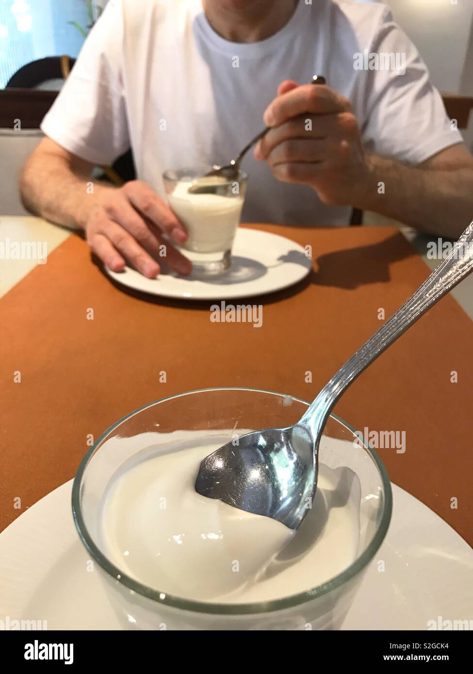 Eating yoghurt creams. - Smartphone Captured Stock Image