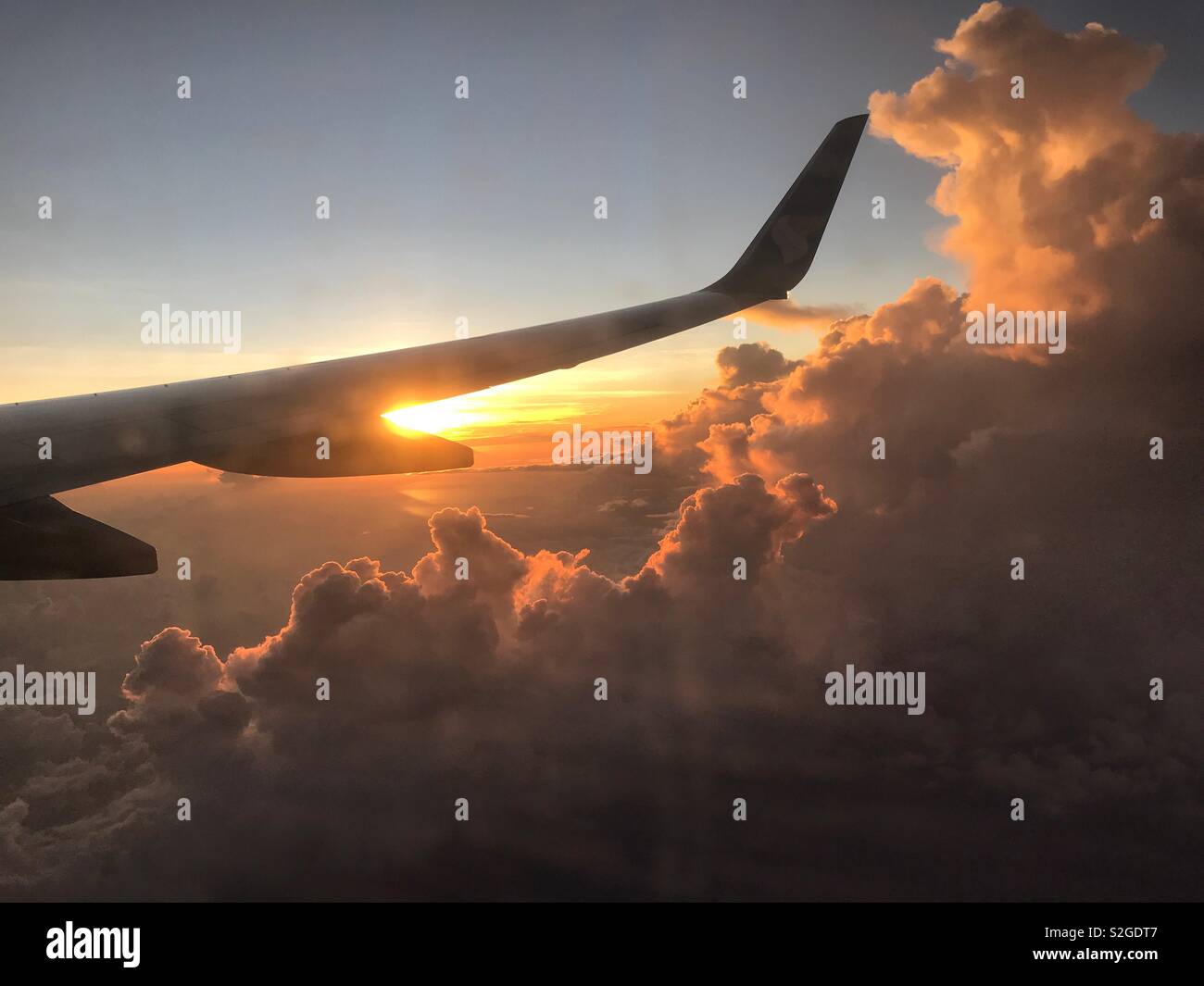 Morning flight: Sunrise while in the sky. watching the sun through the clouds at early morning. A flight from Zanzibar - Smartphone Captured Stock Image