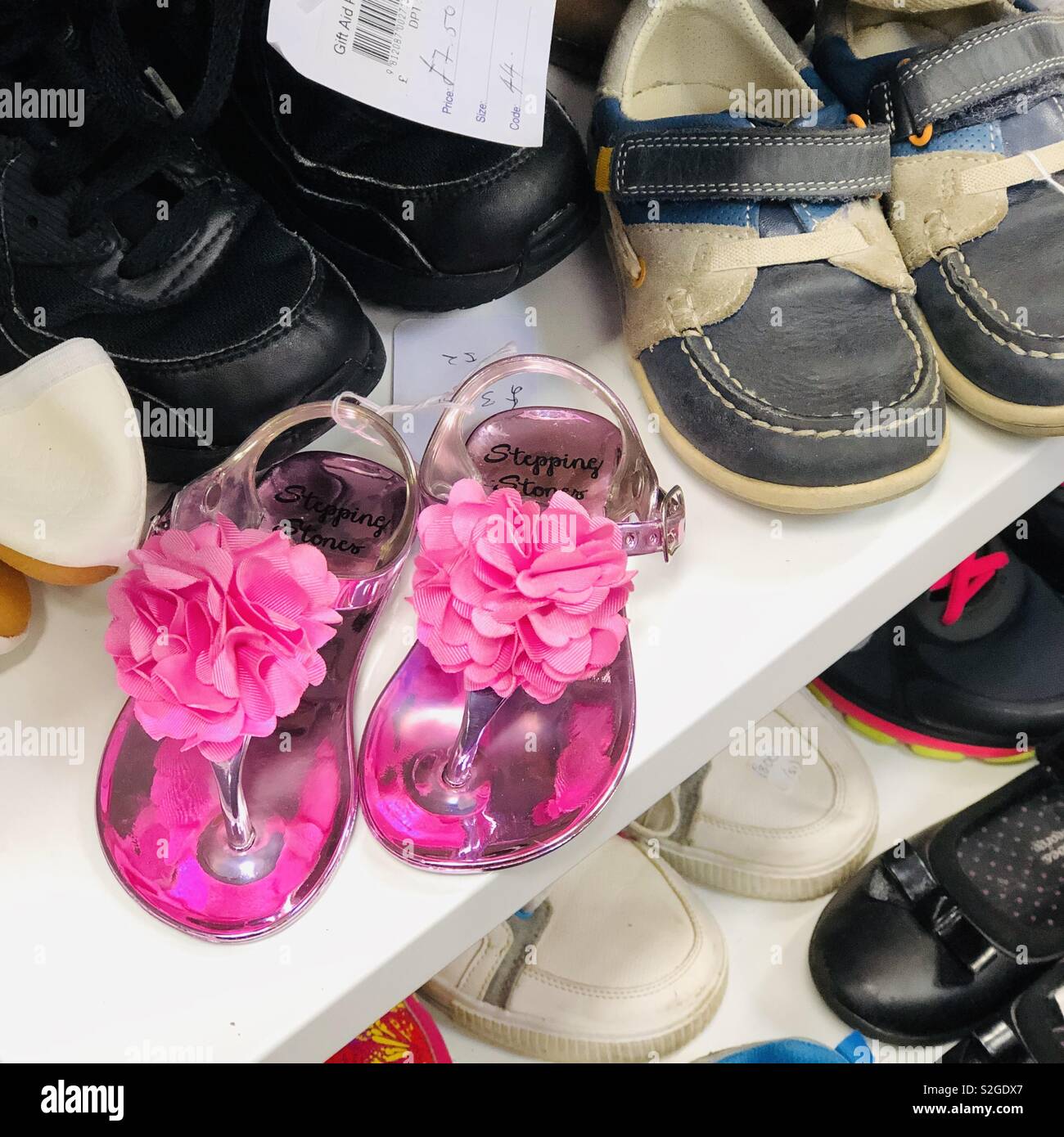 Children’s shoes in charity shop. Scotland. UK. Stock Photo