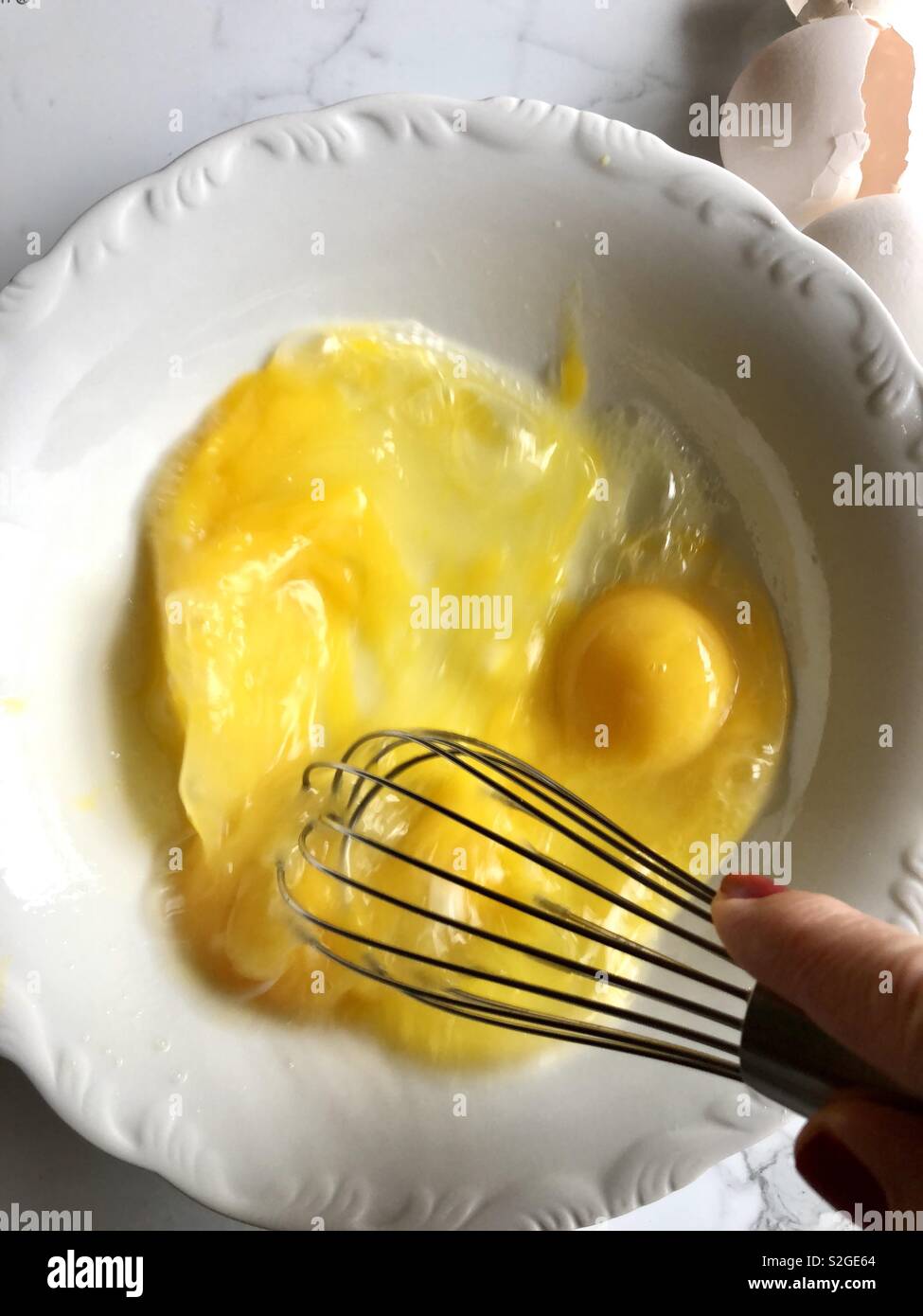Whisking eggs in a white bowl - Smartphone Captured Stock Image