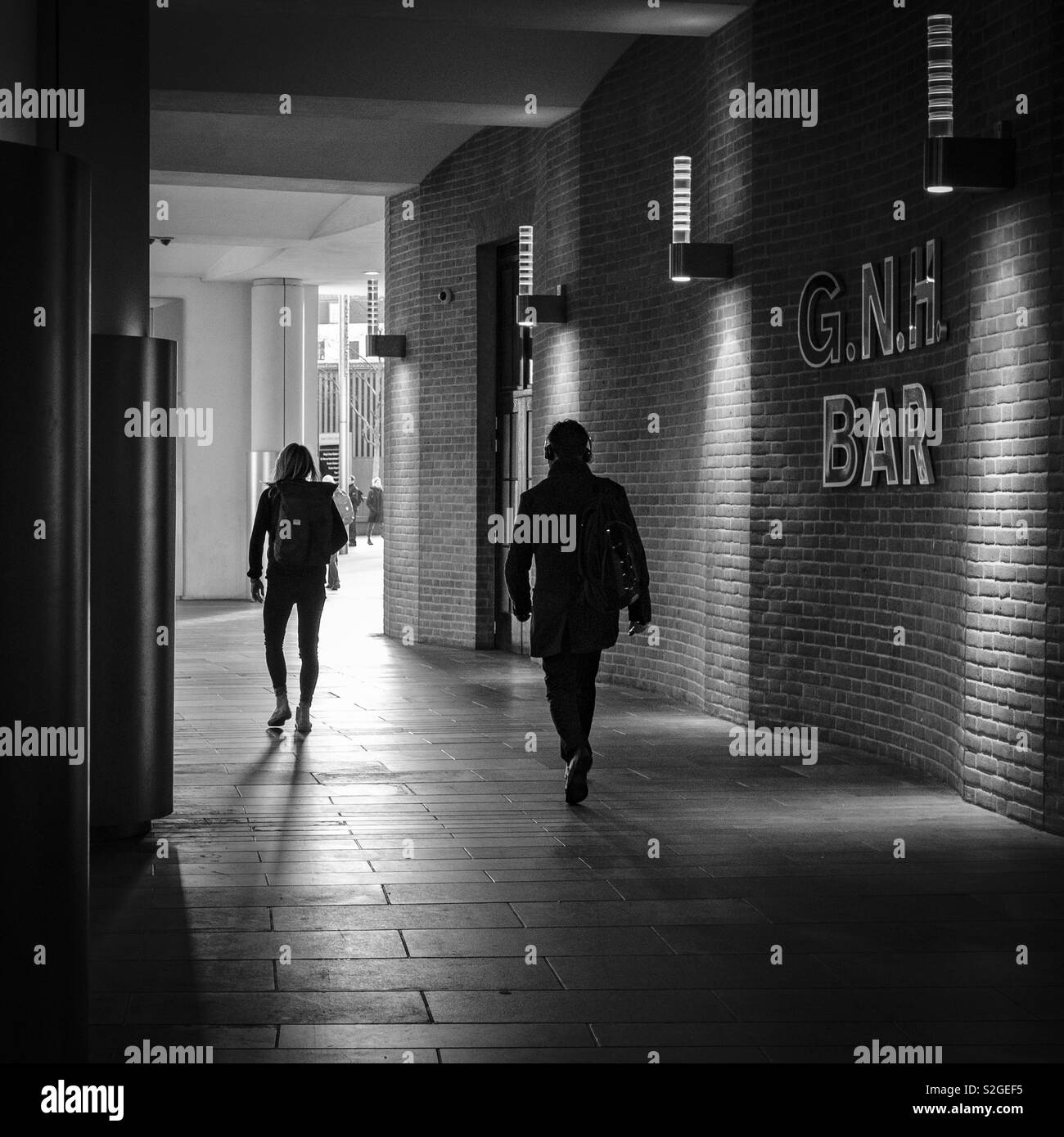 People in Silhouette walking through London Kings Cross railway station. Stock Photo