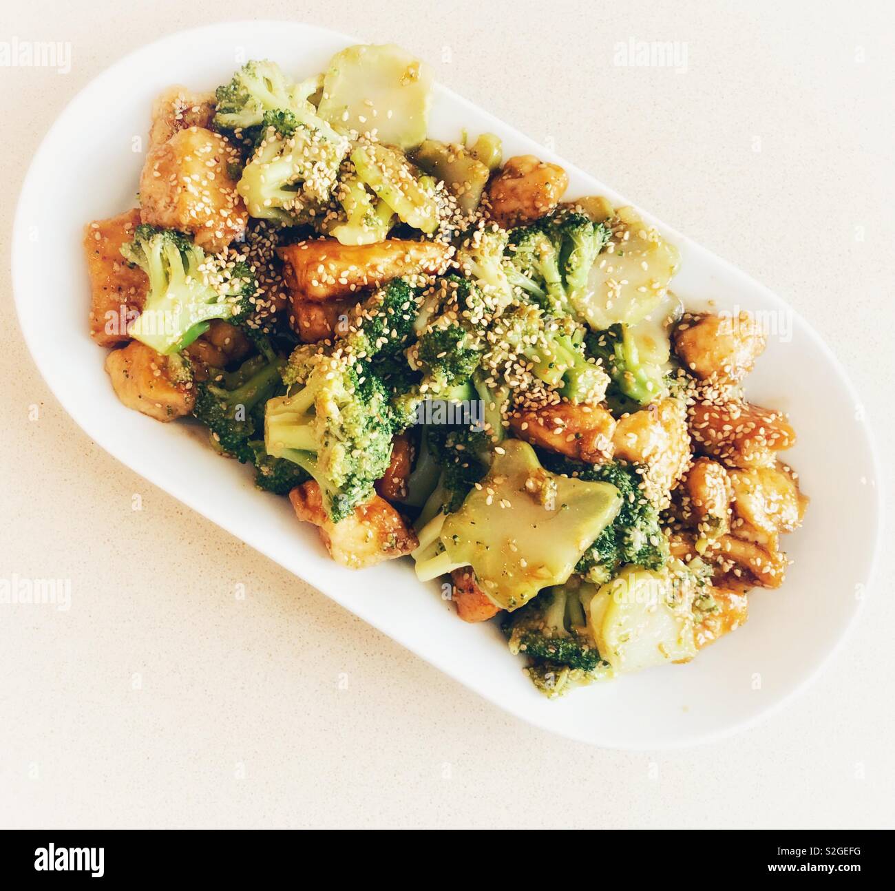 Chicken and broccoli with sesame seeds and soy sauce and honey Stock Photo