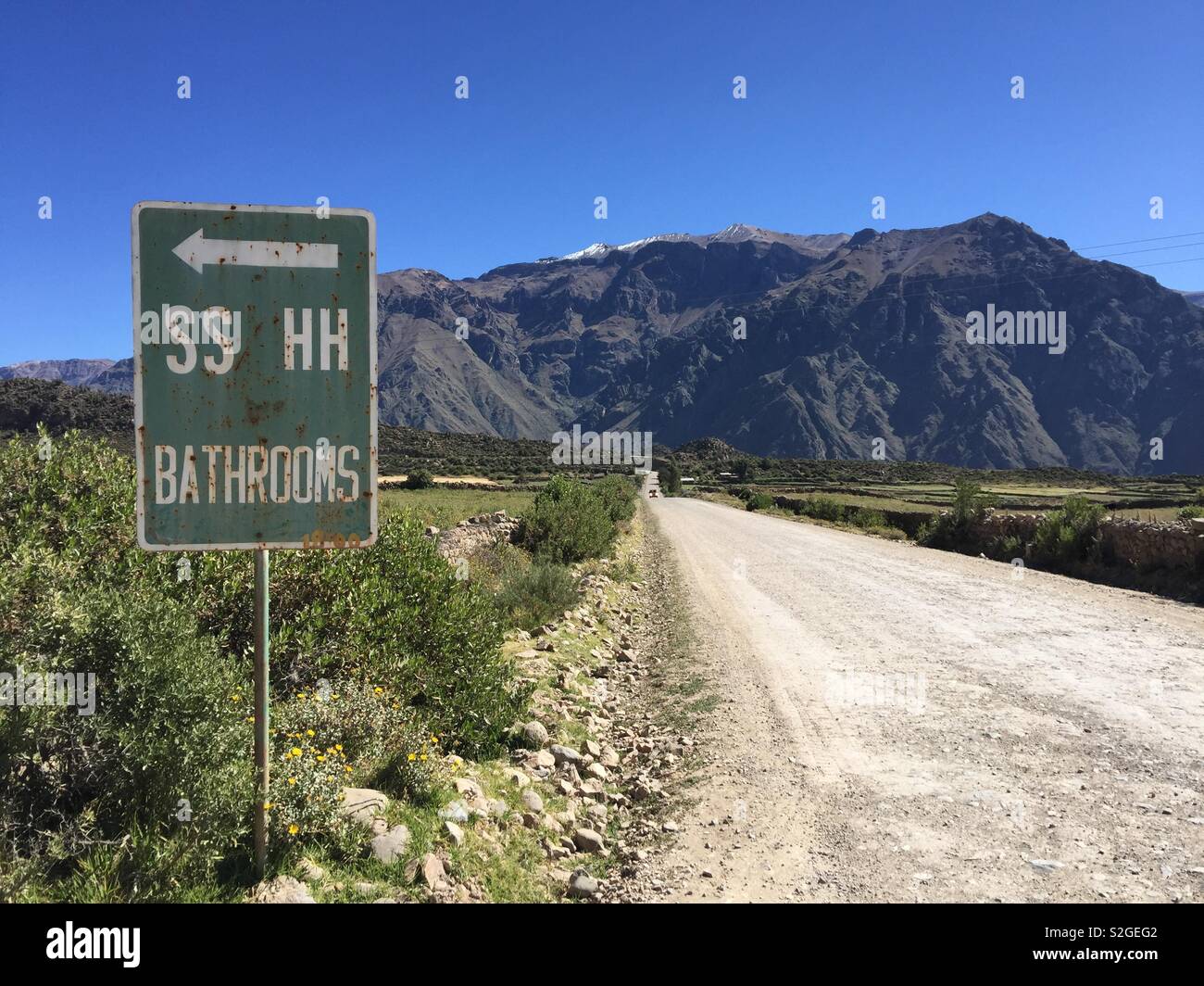 Bathroom road sign in Peruvian Andes Stock Photo - Alamy