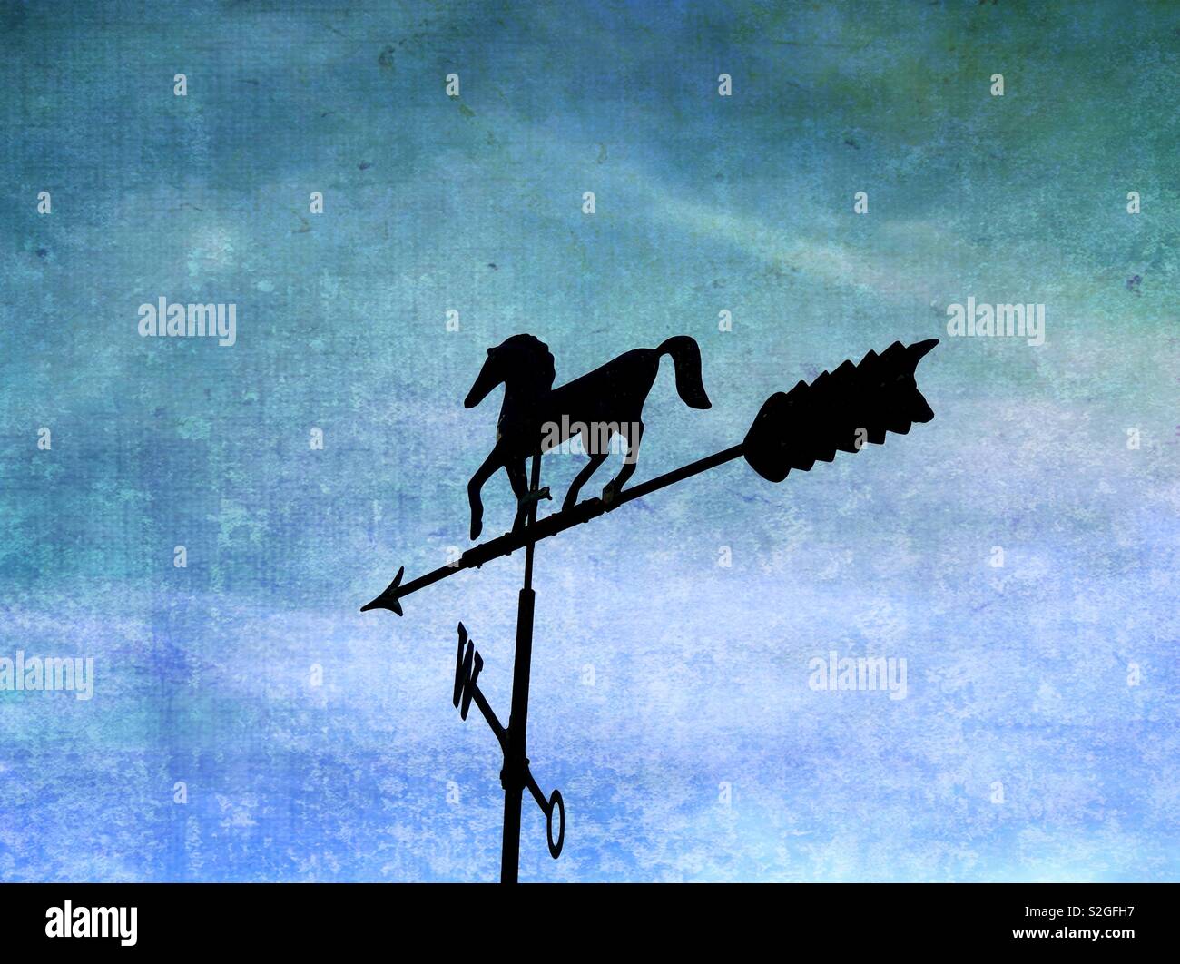 Horse-shaped weathervane against grungy background - Smartphone Captured Stock Image