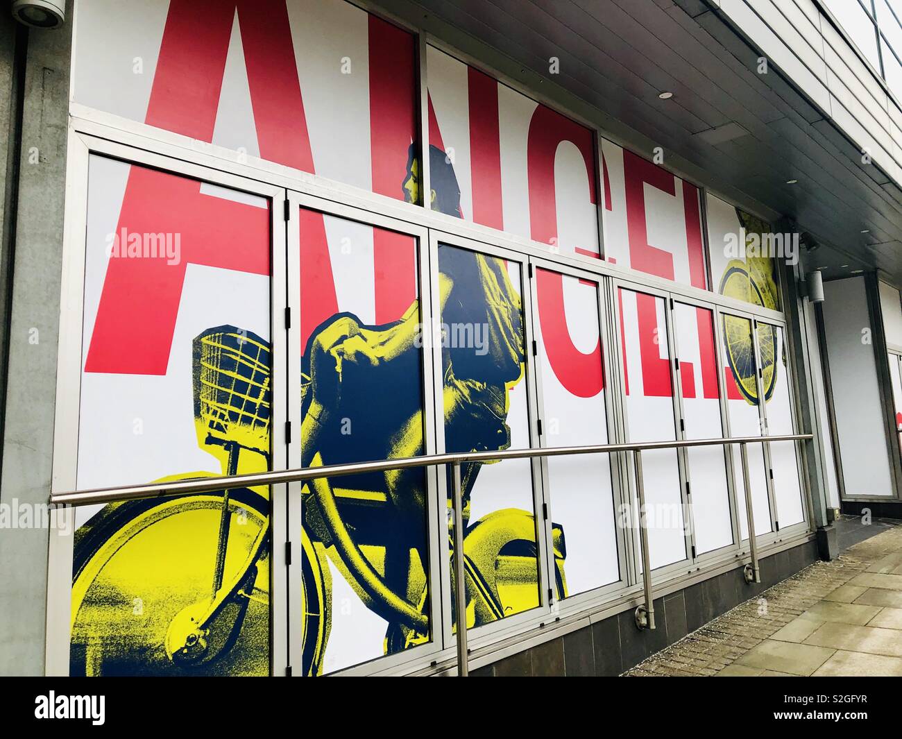 Angel Islington empty shop boarding with picture with cyclist Stock