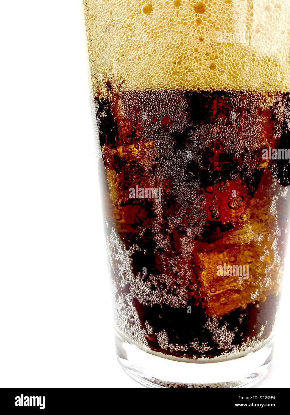 Glass of fizzy cola on white background Stock Photo