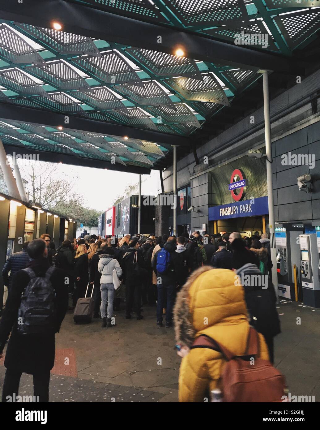 Chaos at Finsbury Park tube station at commuter time on a weekday, commuters made to wait outside the station as too crowded, North London, UK - Smartphone Captured Stock Image