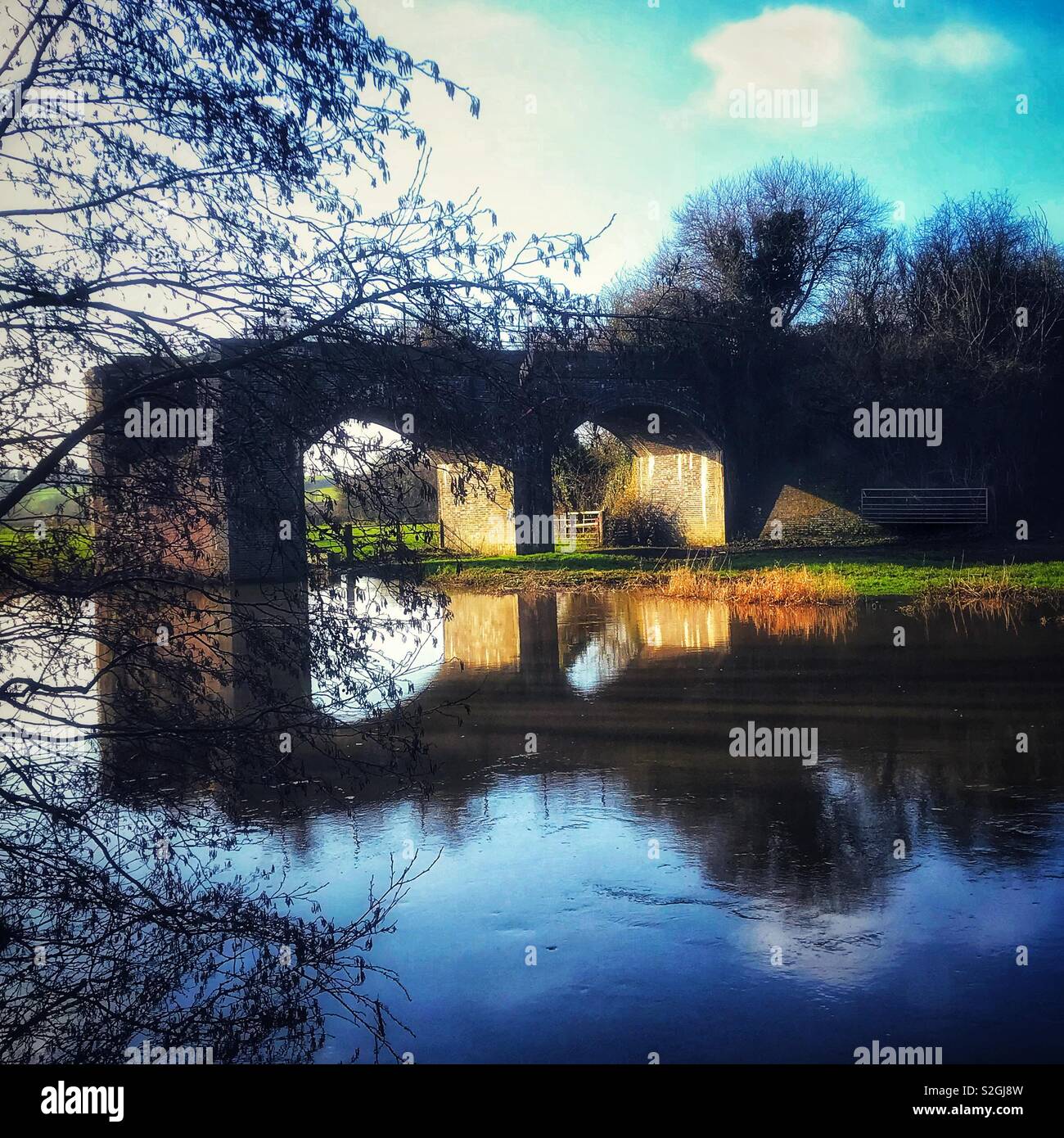 Derelict railway bridge over a river - Smartphone Captured Stock Image