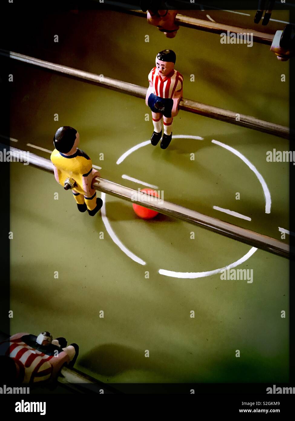 Two players, one from the Chivas and one from Club America face each other as rivals on the Mexican tabletop game of futbolitos. Stock Photo
