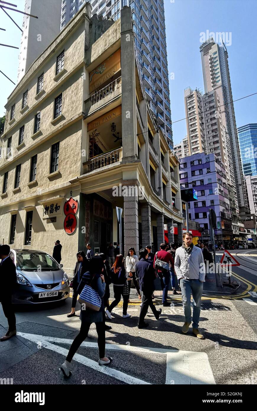 Crowed walking on Johnston street by a beautiful old building in Wan Chai, Hong Kong. - Smartphone Captured Stock Image