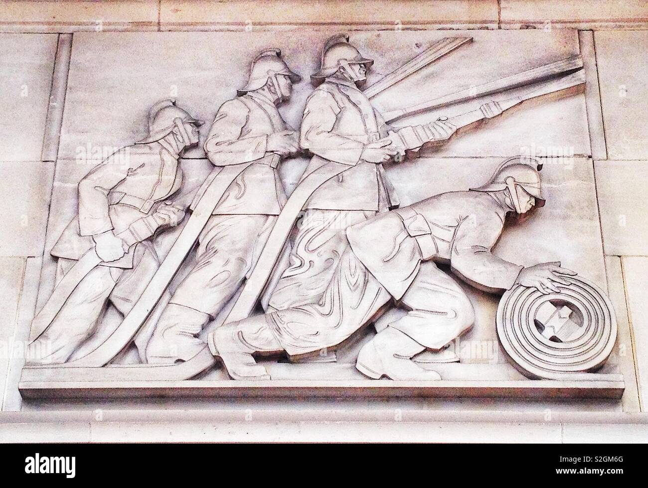 Detail of the 1930's stone carved relief on the former London Fire Brigade headquarters building on the Albert Embankment Stock Photo
