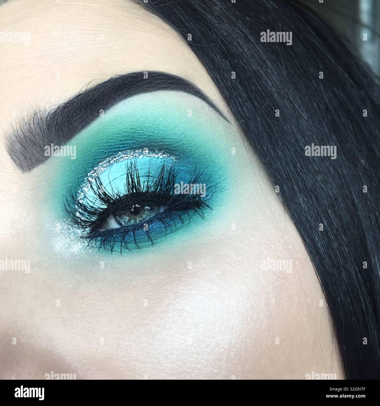 Close up turquoise blue eye makeup Stock Photo