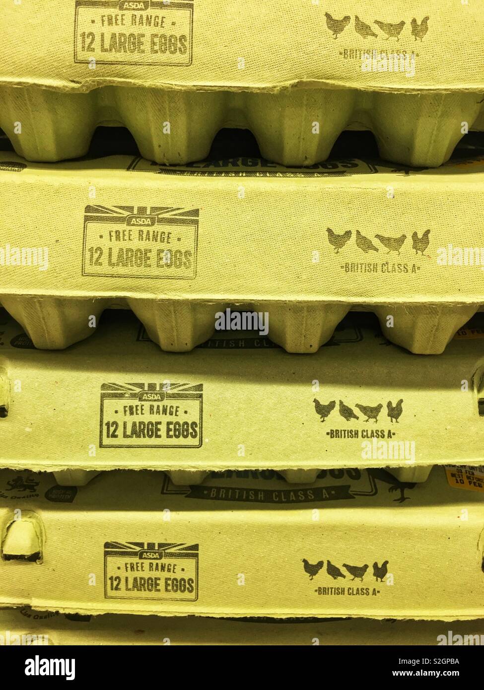 A stack of four egg boxes in a supermarket 12 large eggs in each Stock