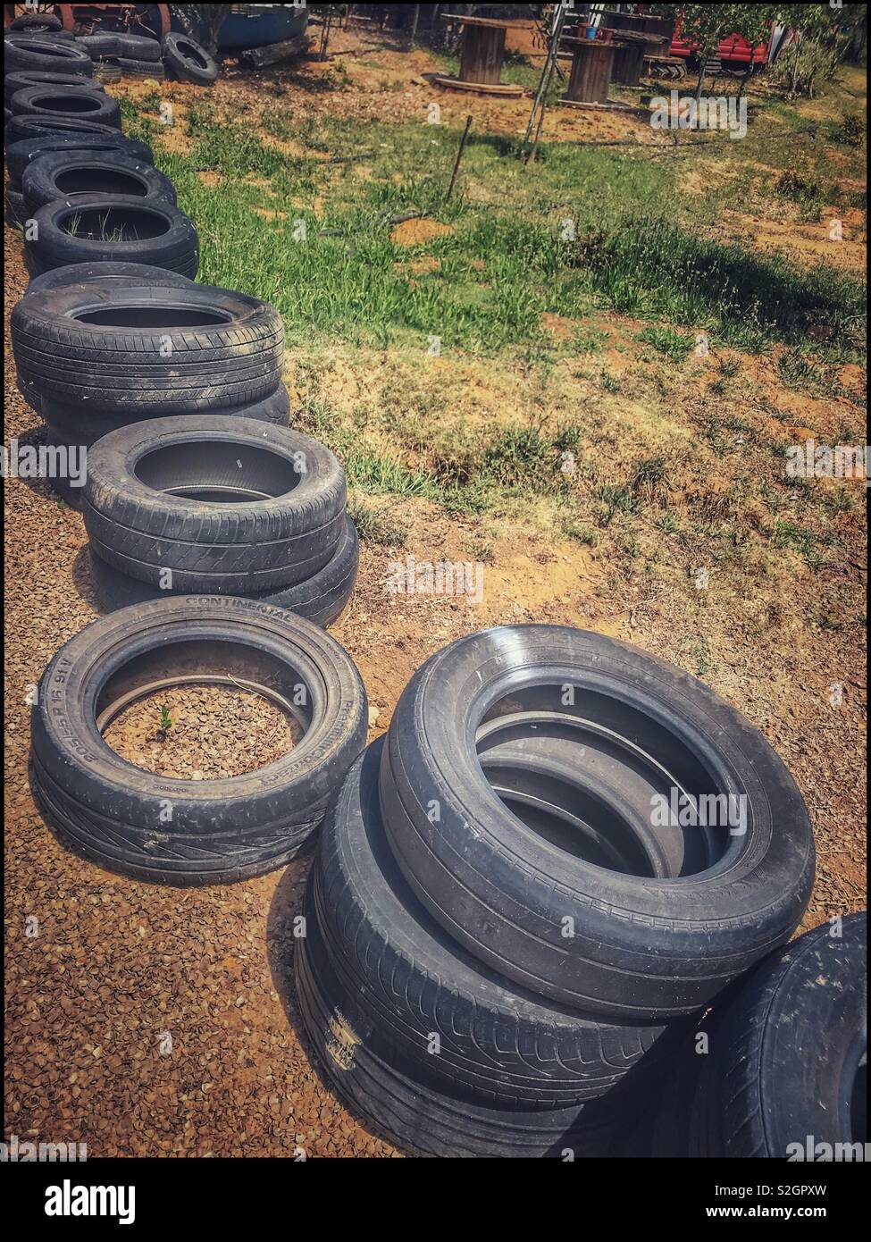 Old used rubber tyres along path at Toeka Stoor in Windmeul near Paarl
