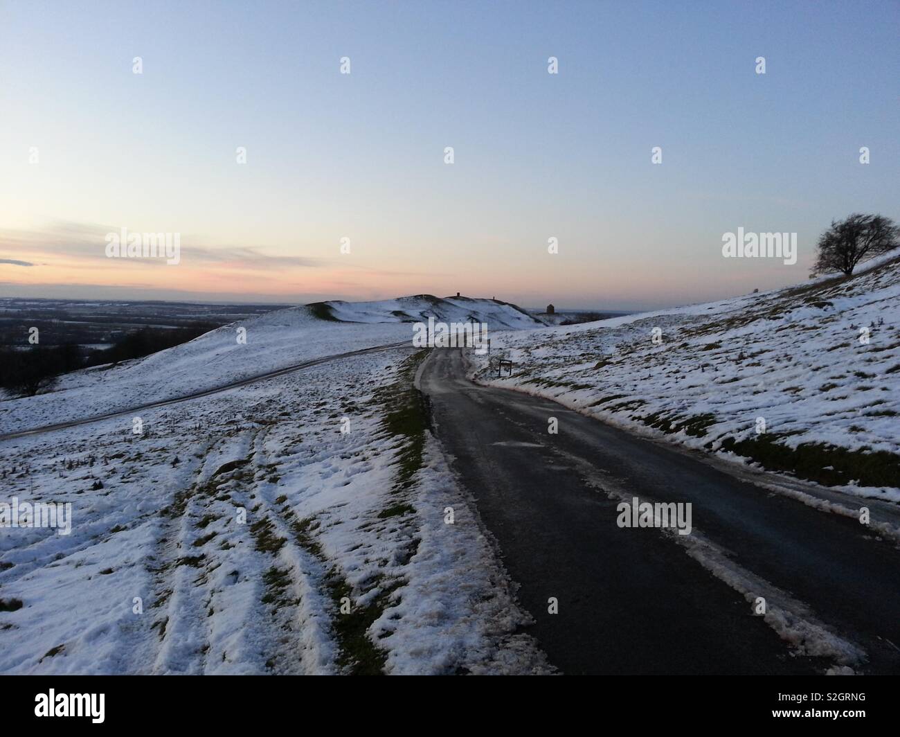 Snow covered Burton Dassett Hills, Warwickshire, with the ancient signal beacon at rear of view. - Smartphone Captured Stock Image