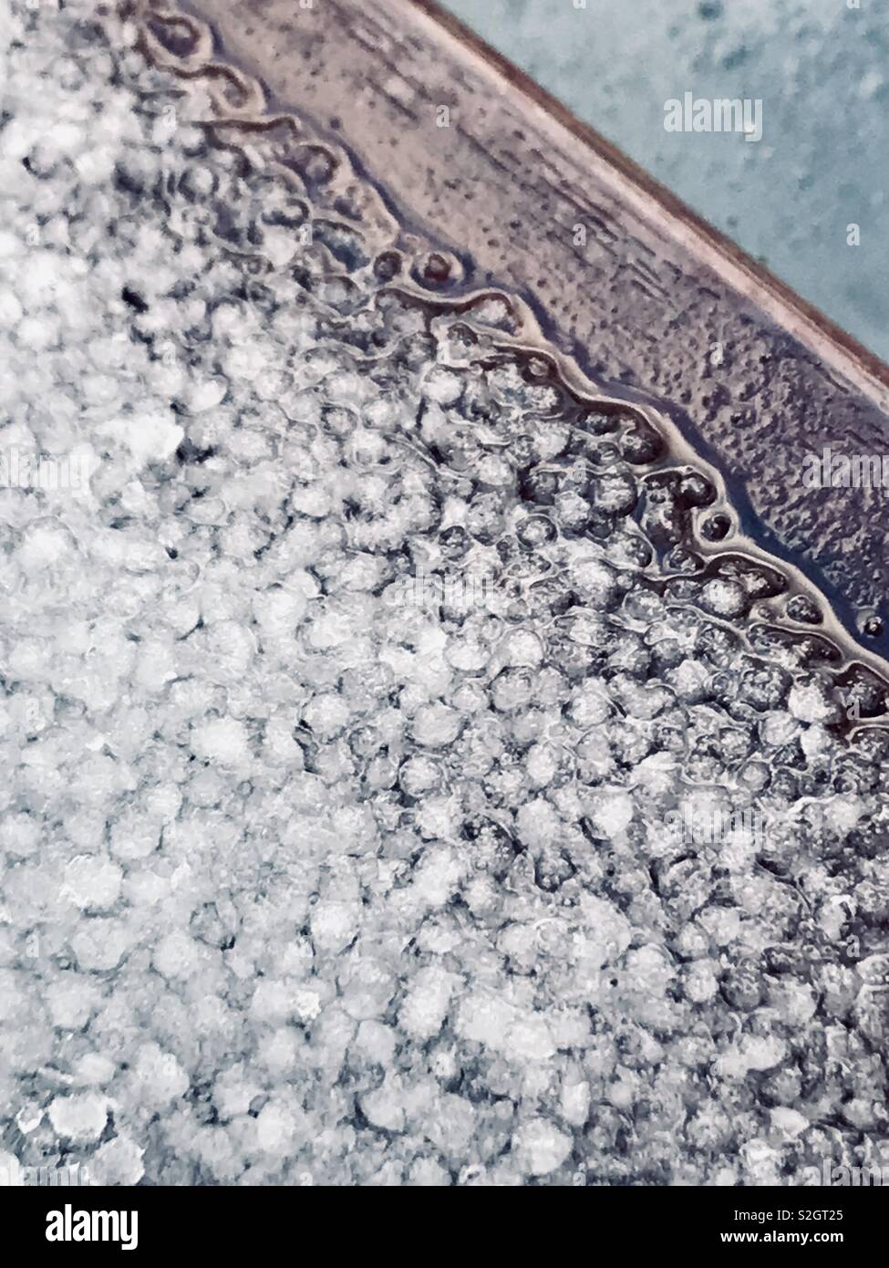 Hail stones in January on a wooden sill. Stock Photo