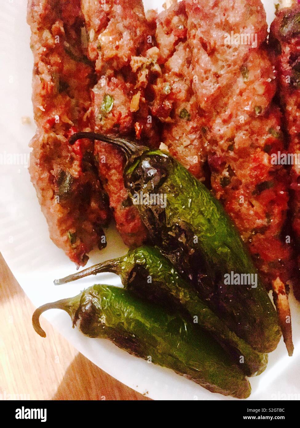 Grilled kebabs and green chili peppers Stock Photo Alamy