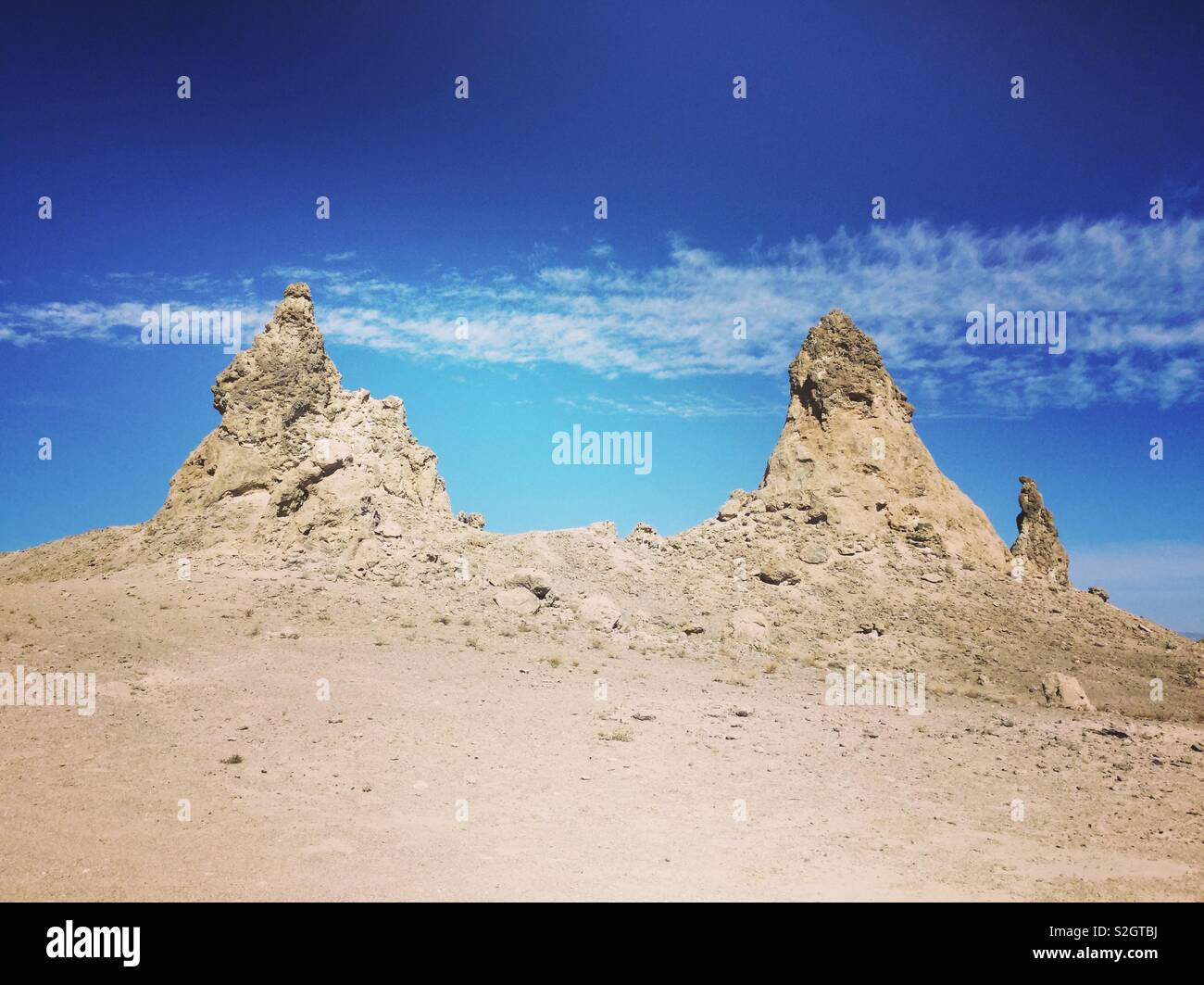 Trona Pinnacles against a blue sky with white clouds. Barren Pinnacles in desert. Stock Photo