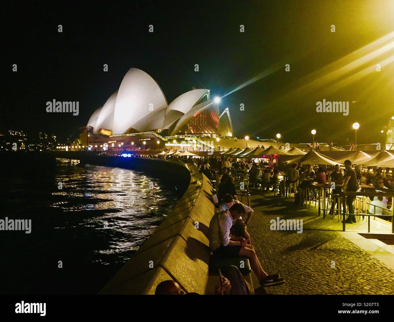 Sydney Opera House lit up at night on the harbour in Australia, NSW Stock Photo
