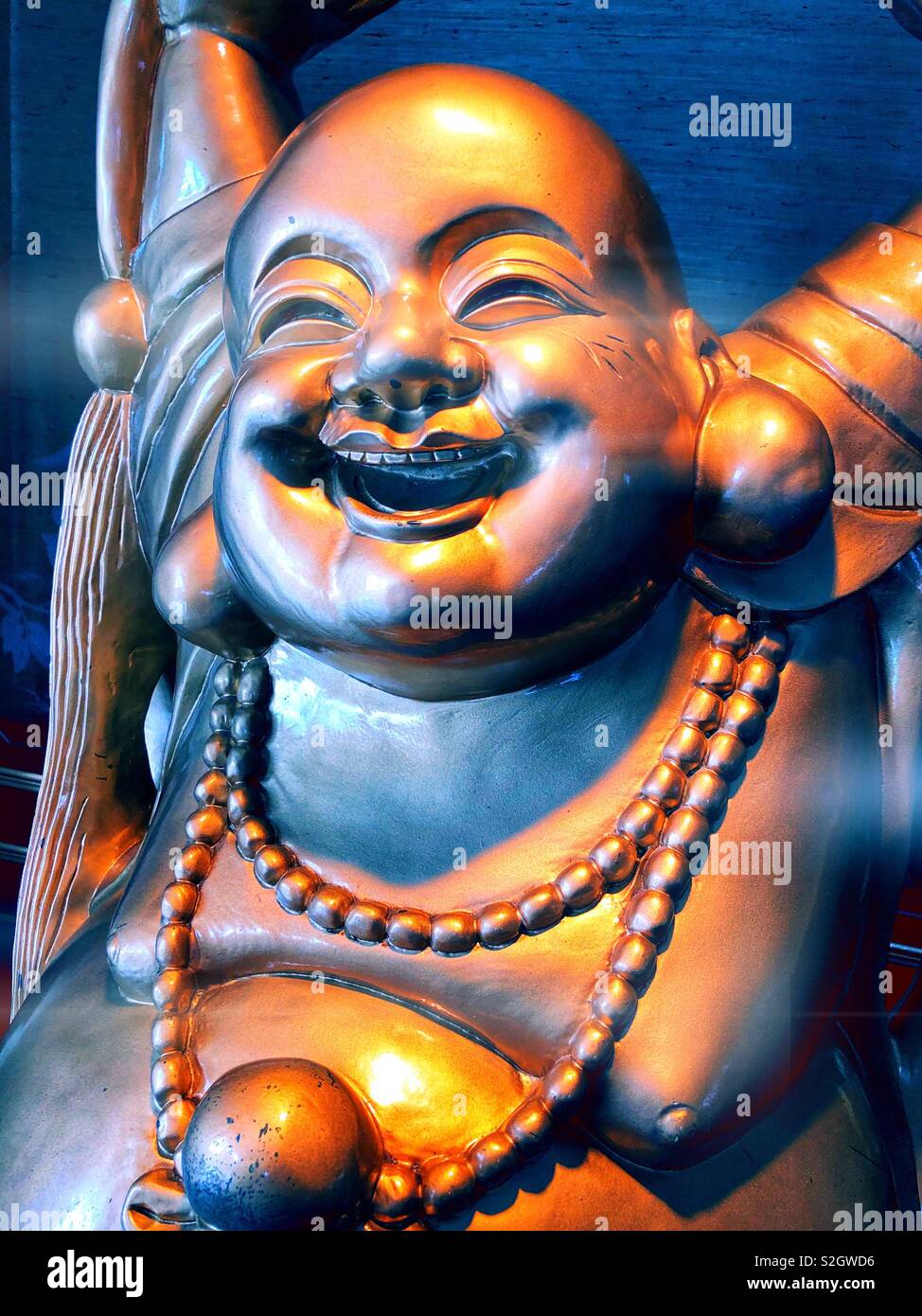 Face of smiling Buddha, Chinese god of happiness, wealth and luck Stock Photo