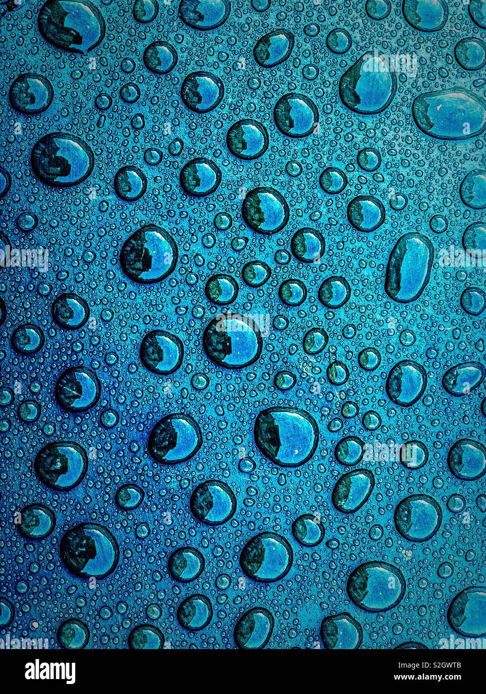 Water droplets on blue surface - Smartphone Captured Stock Image