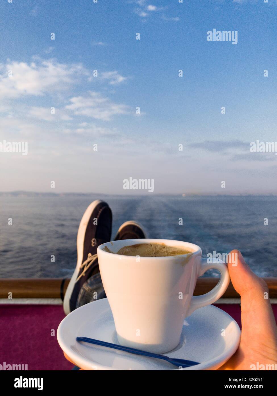 Man drinking coffee on cruise ship Stock Photo