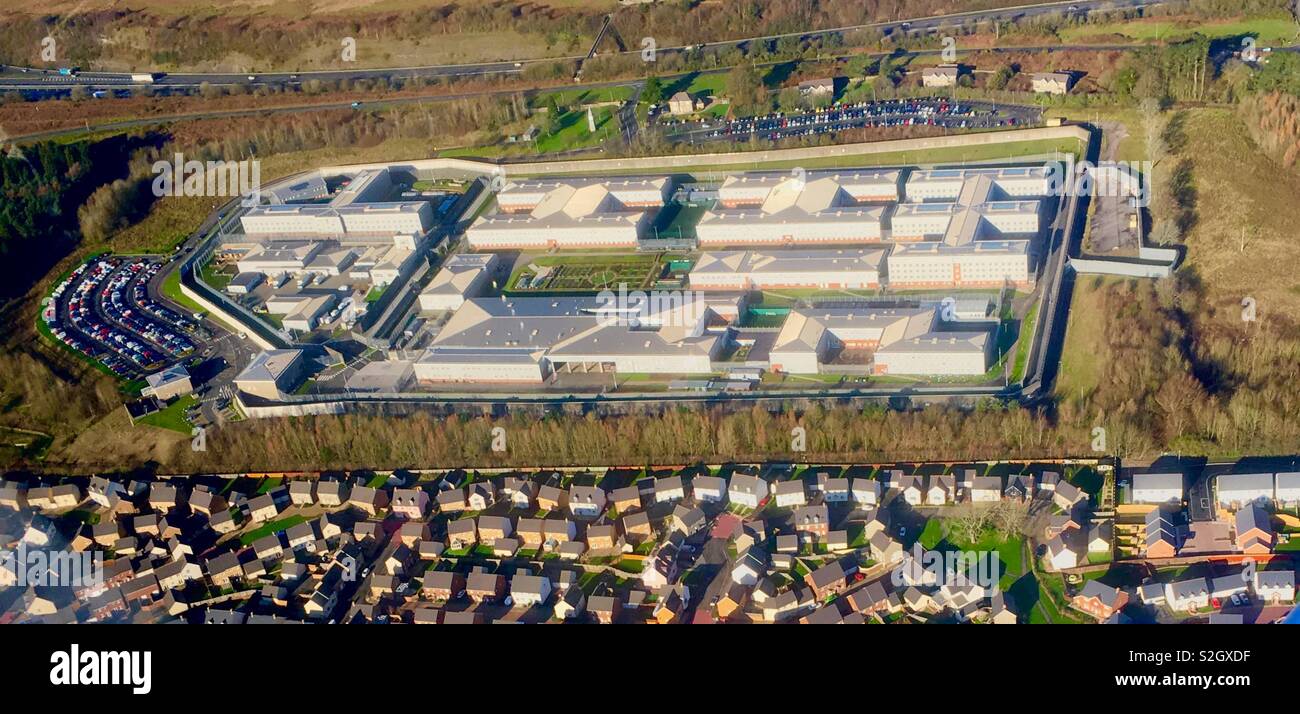 Aerial view of parc prison (4000ft) with housing estate visible Stock Photo