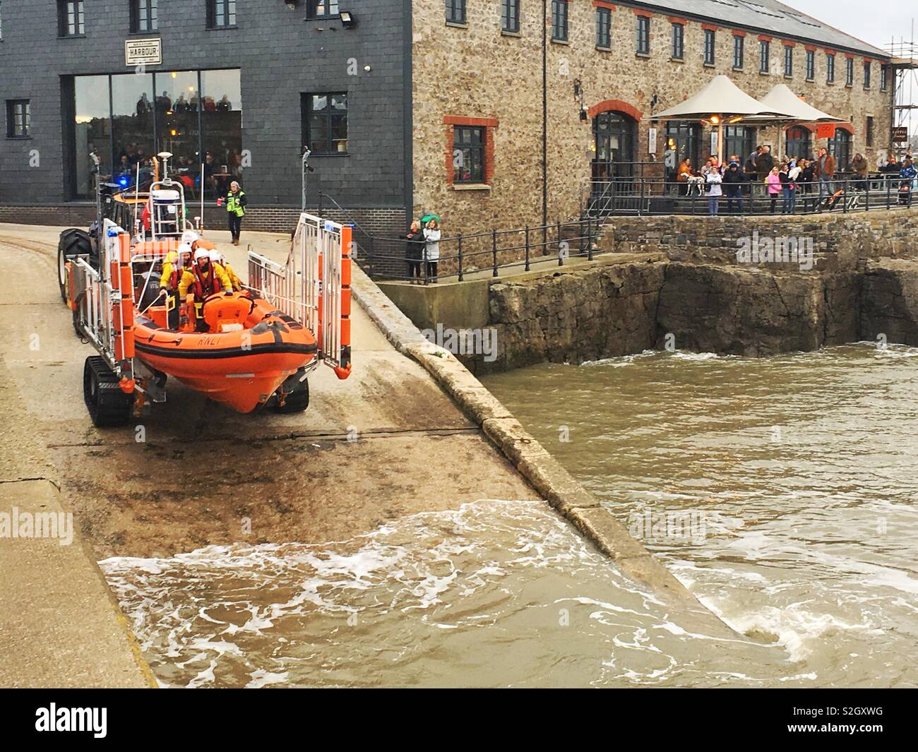 To the rescue! Lifeboat launches to mayday distress call whilst public watch Stock Photo