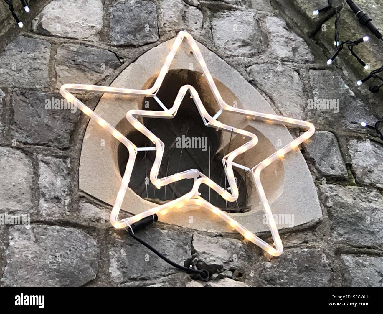A Christmas Star decoration on a church. - Smartphone Captured Stock Image