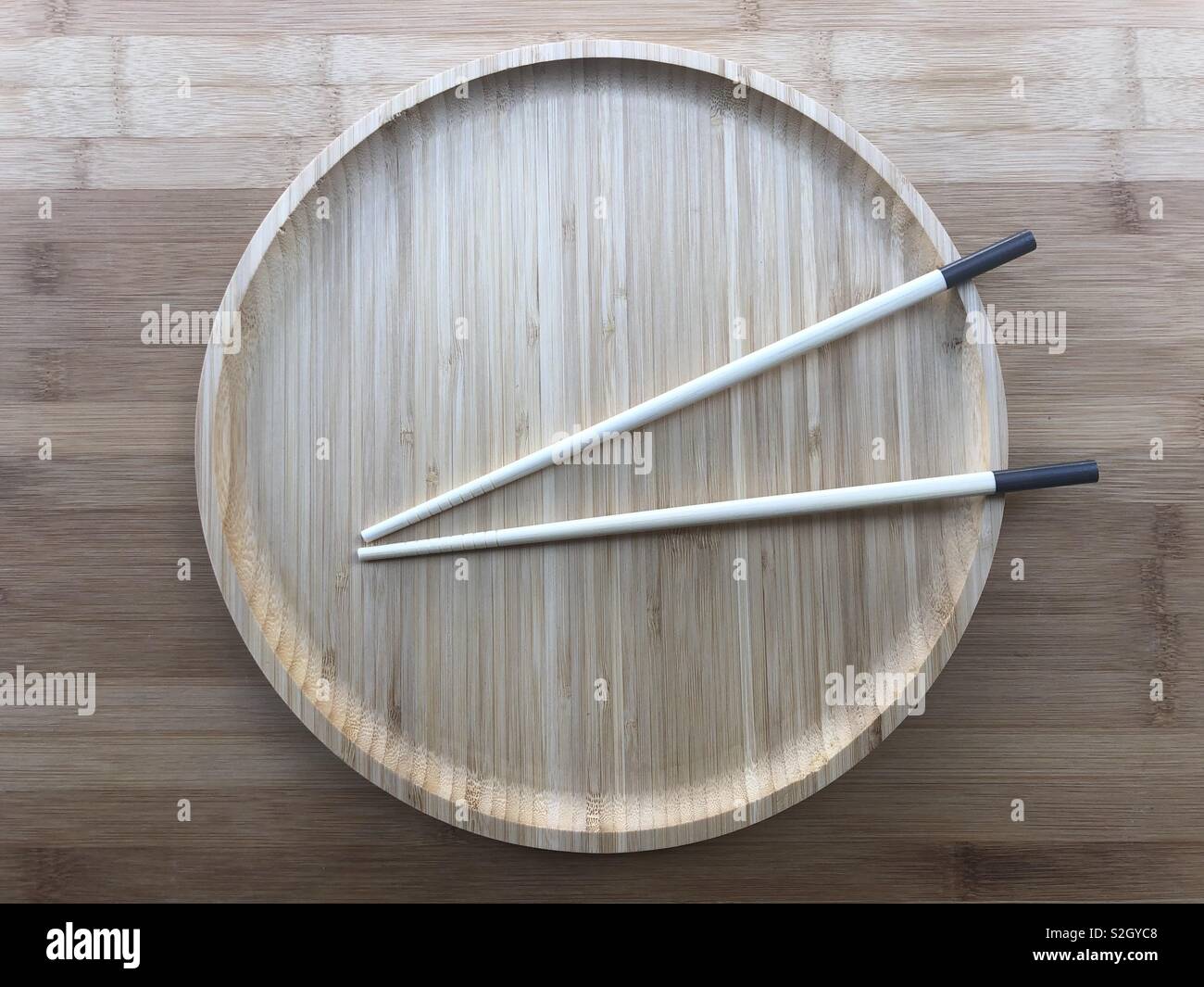 Wooden dish whith chinese sticks - Smartphone Captured Stock Image