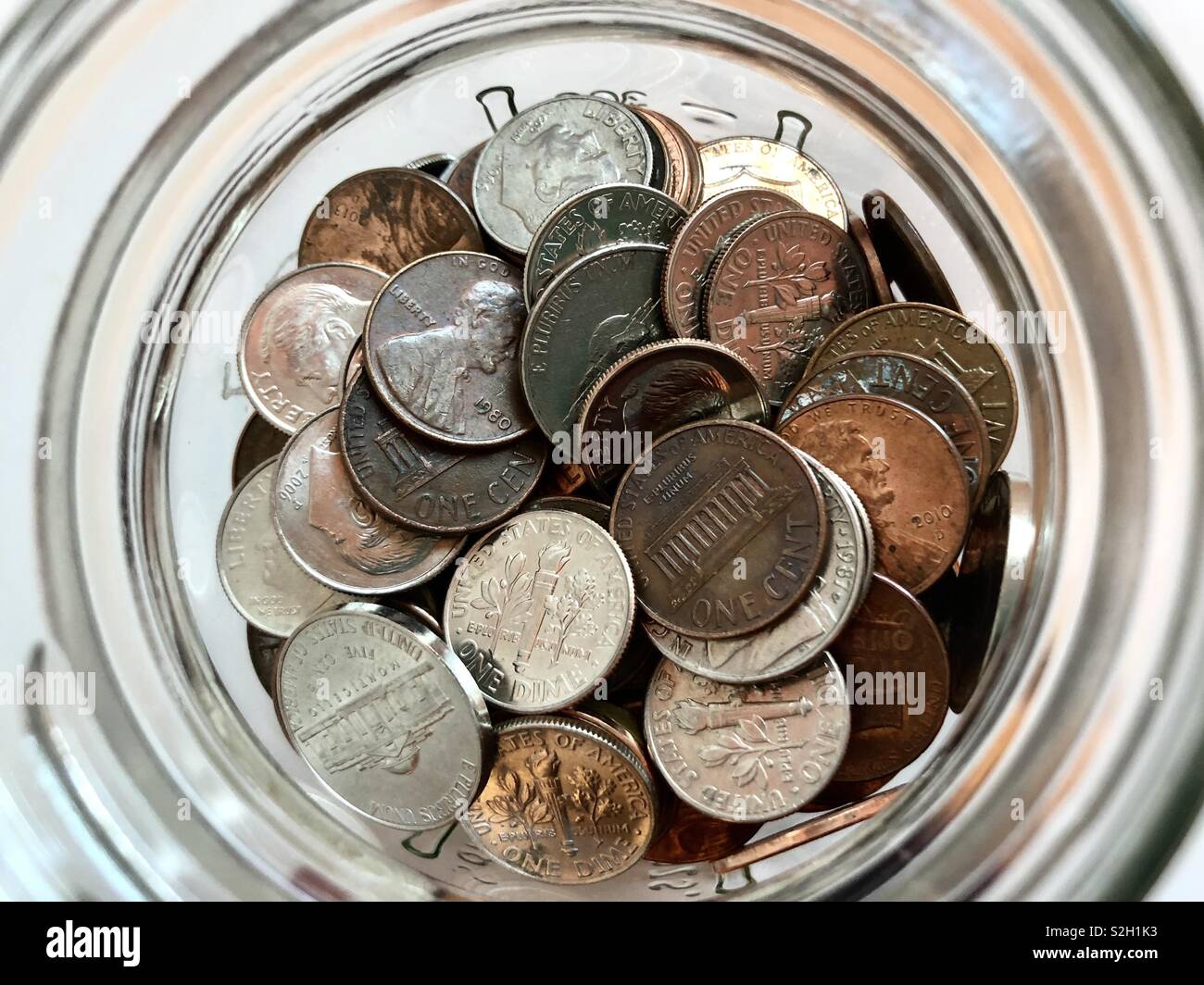 Top view of coins in a glass jar Stock Photo