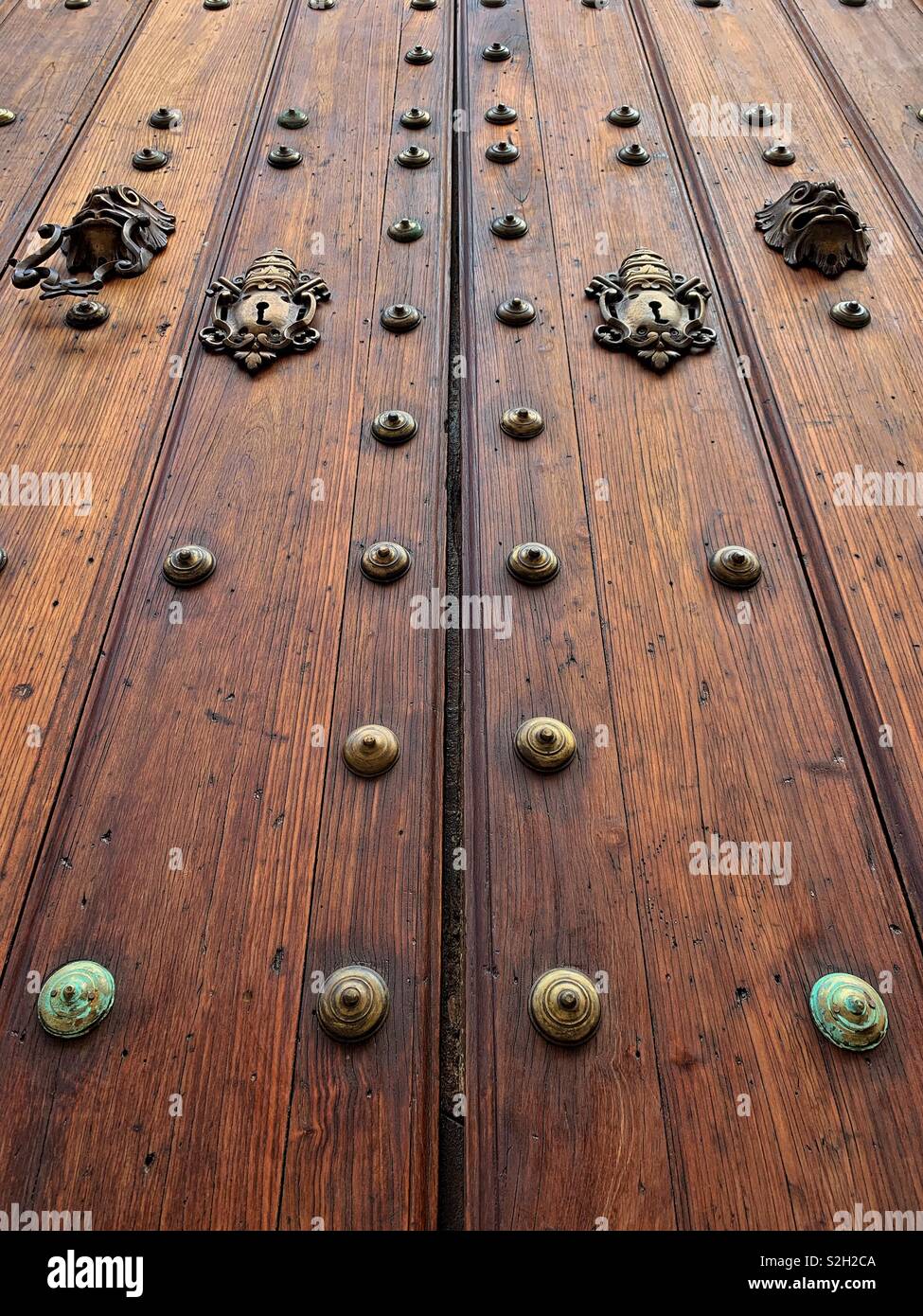 Looking up at massive wood church door with brass details in old Havana Cuba - Smartphone Captured Stock Image