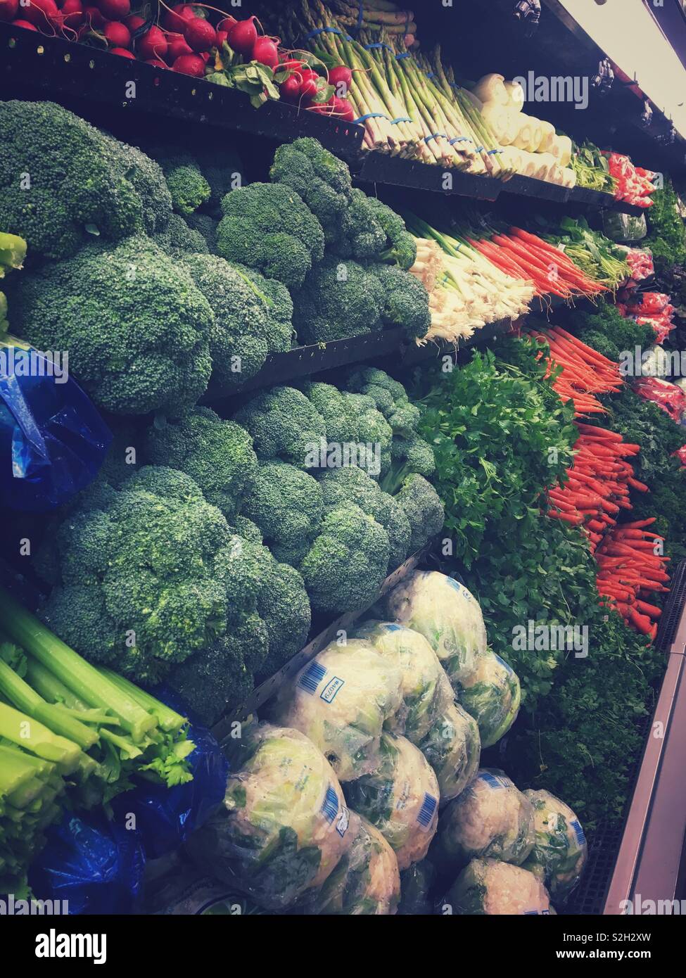 Vegetables on shelves at a produce isle at a grocery store. Stock Photo