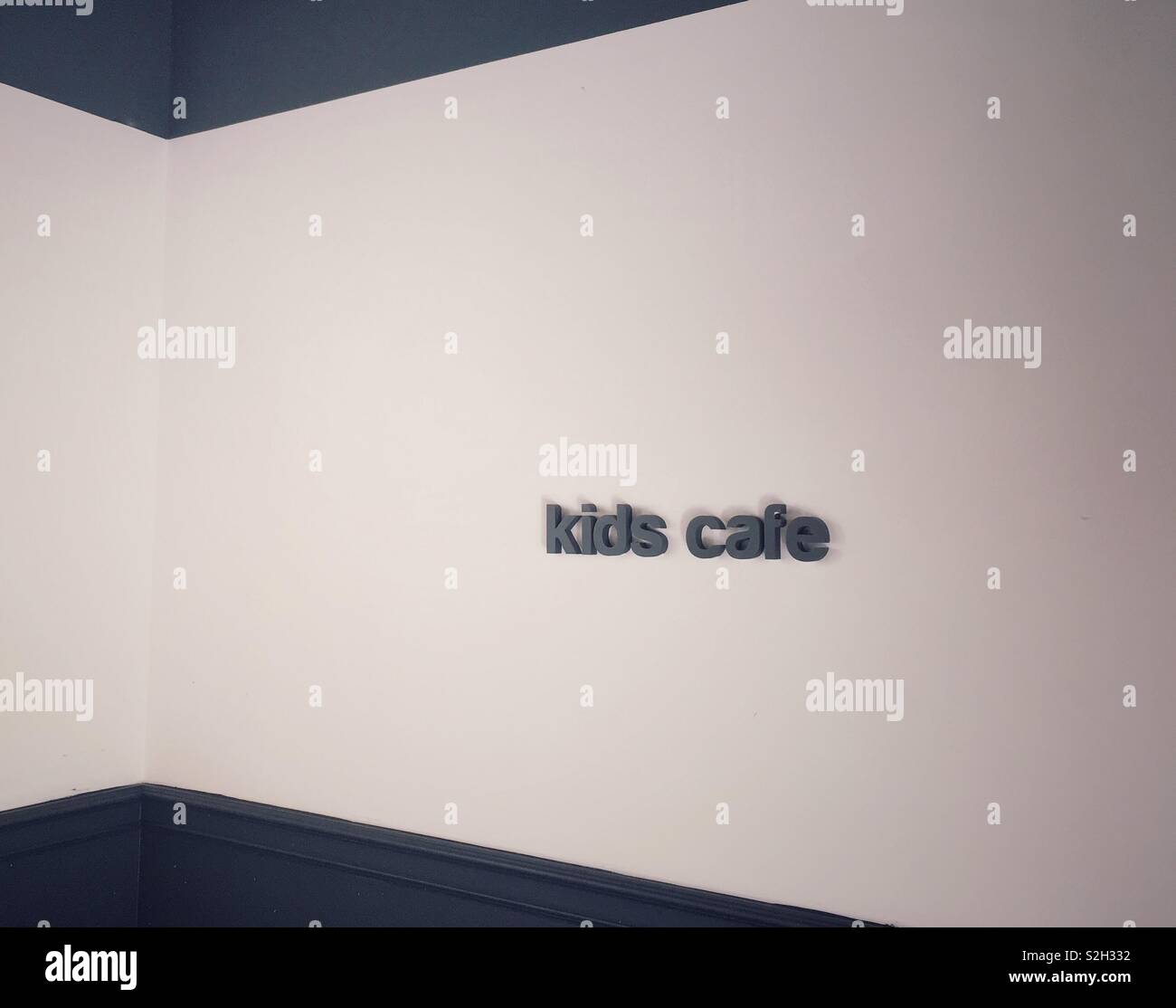 Kids cafe sign on a wall. Copy space. - Smartphone Captured Stock Image