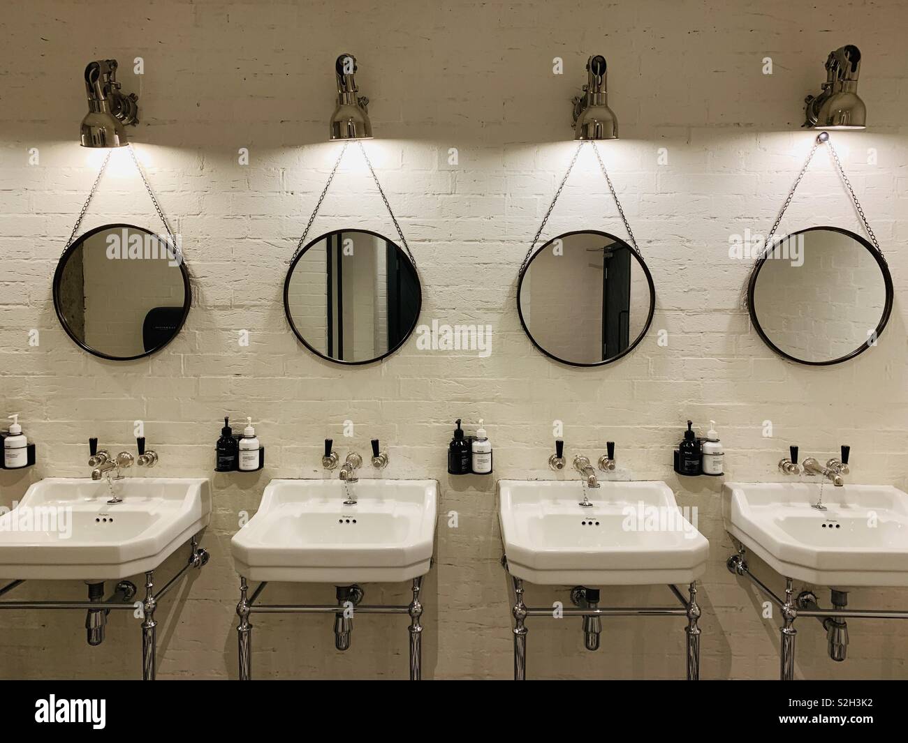 Row of bathroom basins and mirrors Stock Photo