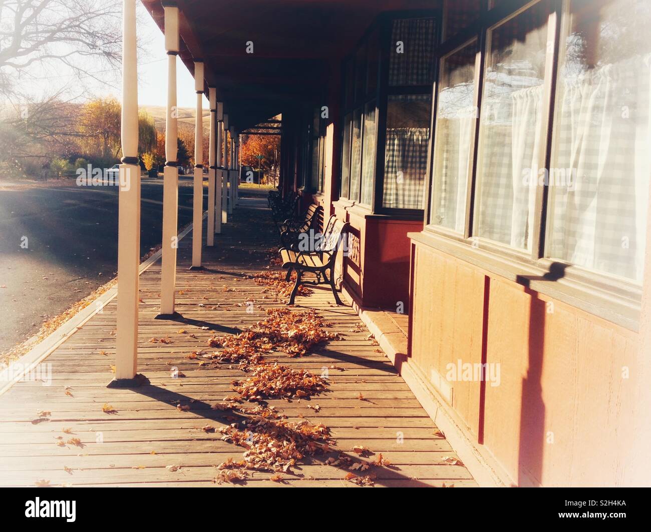 Sunlit photo of wooden plank walkway in front of Old West type store - Smartphone Captured Stock Image