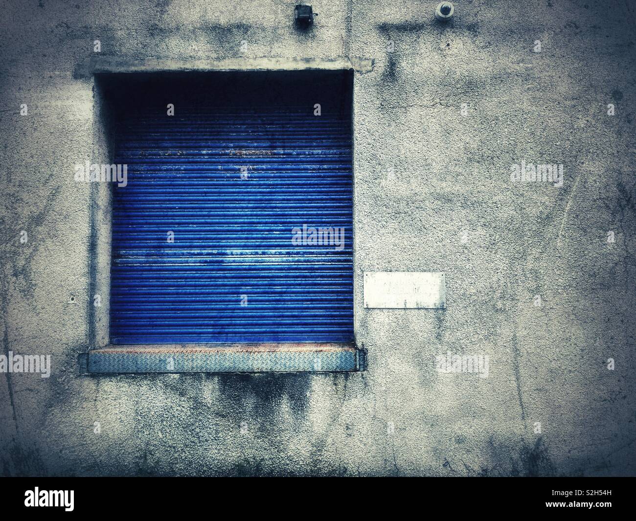 Concrete wall with blue shuttered window - Smartphone Captured Stock Image