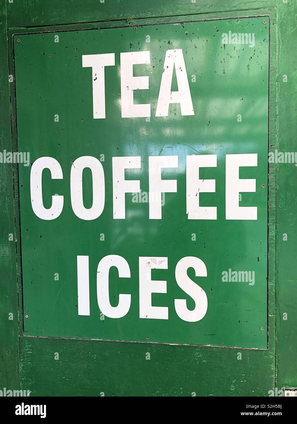 Sign advertising tea, coffee, ices White text on a green background - Smartphone Captured Stock Image