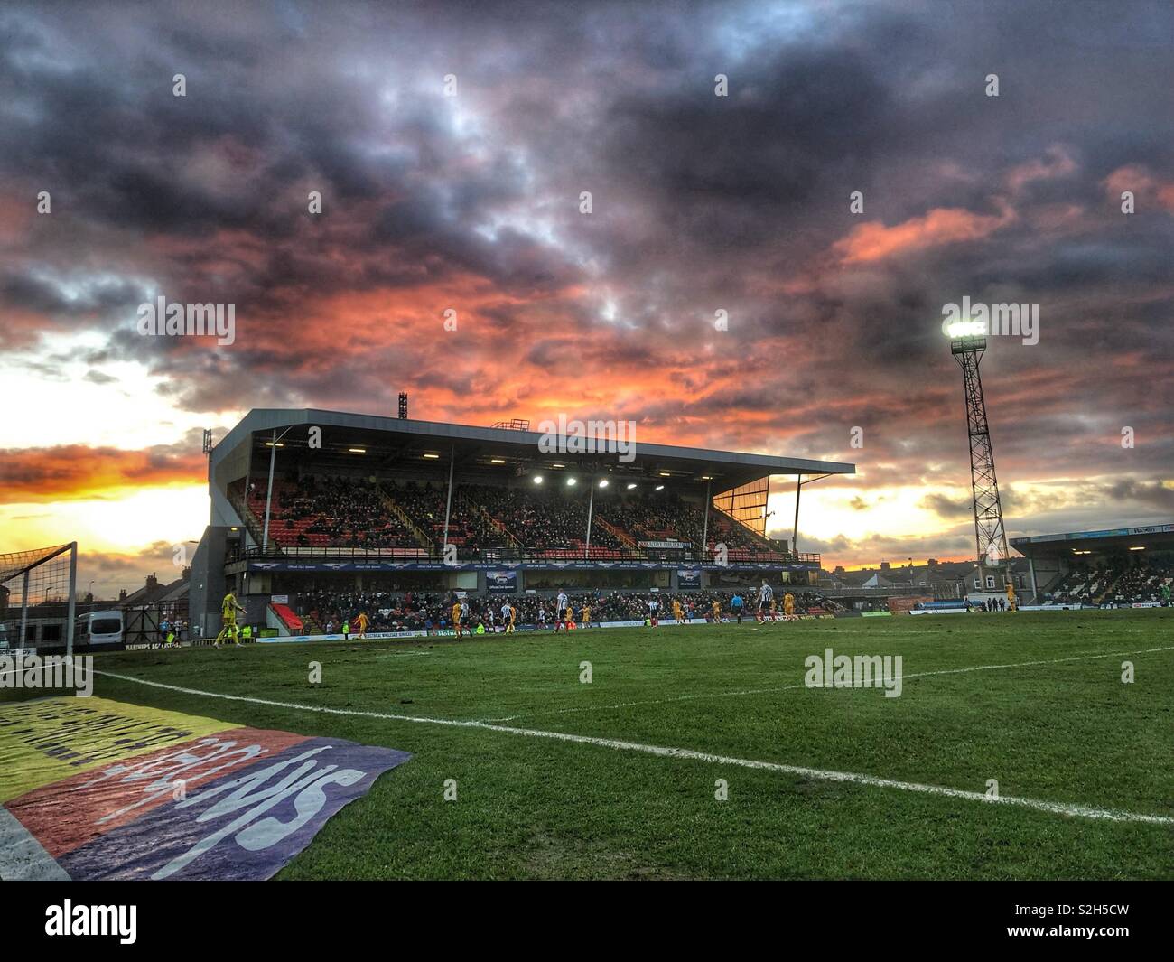 Dramatic skies over Blundell Park in Cleethorpes as Grimsby Town FC takes on Newport County in a EFL league two match Stock Photo