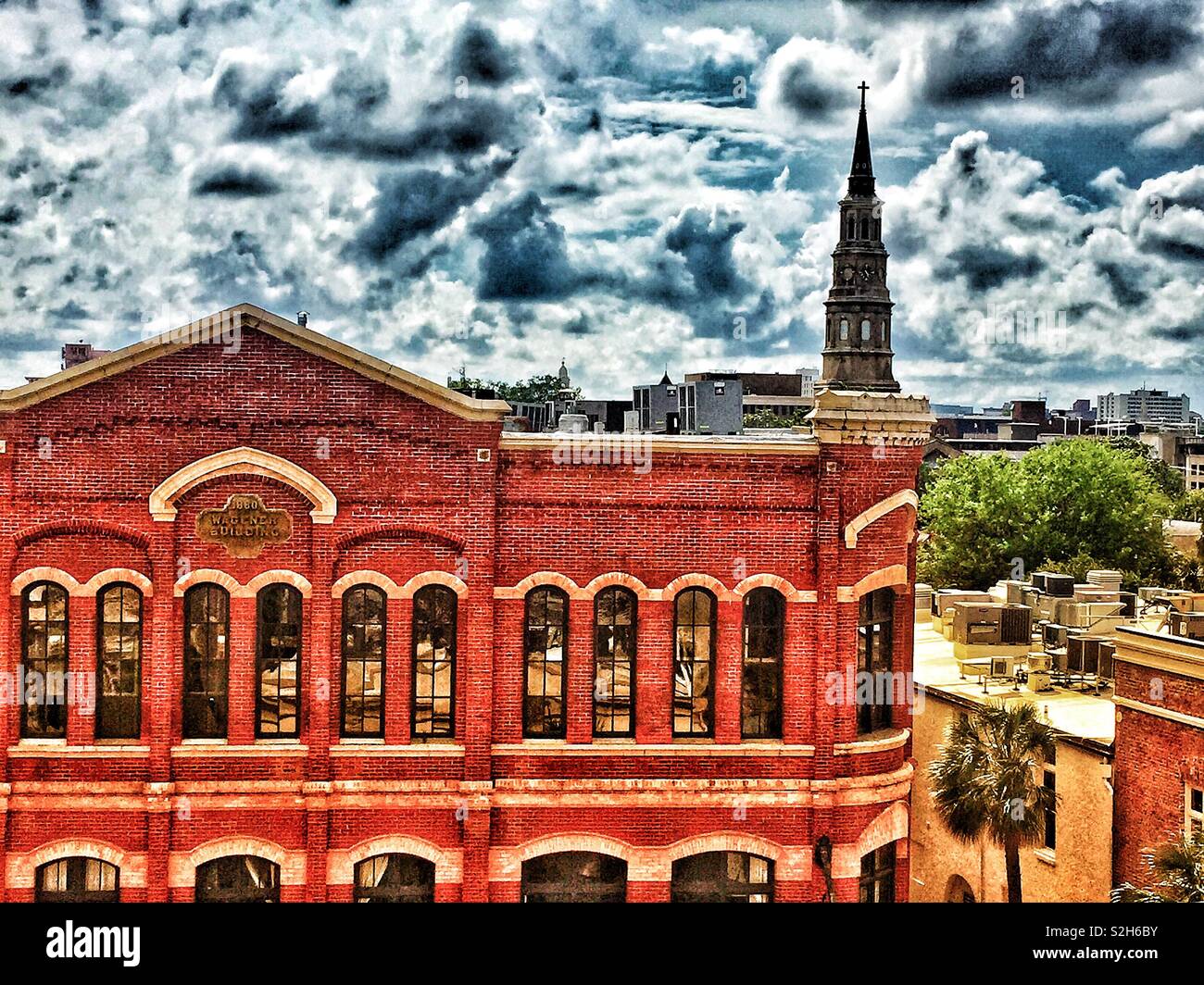 Picture of the FW Wagener Building from a rooftop bar in Charleston SC.  Huge, high Victorian structure with large, high arched windows. Stock Photo