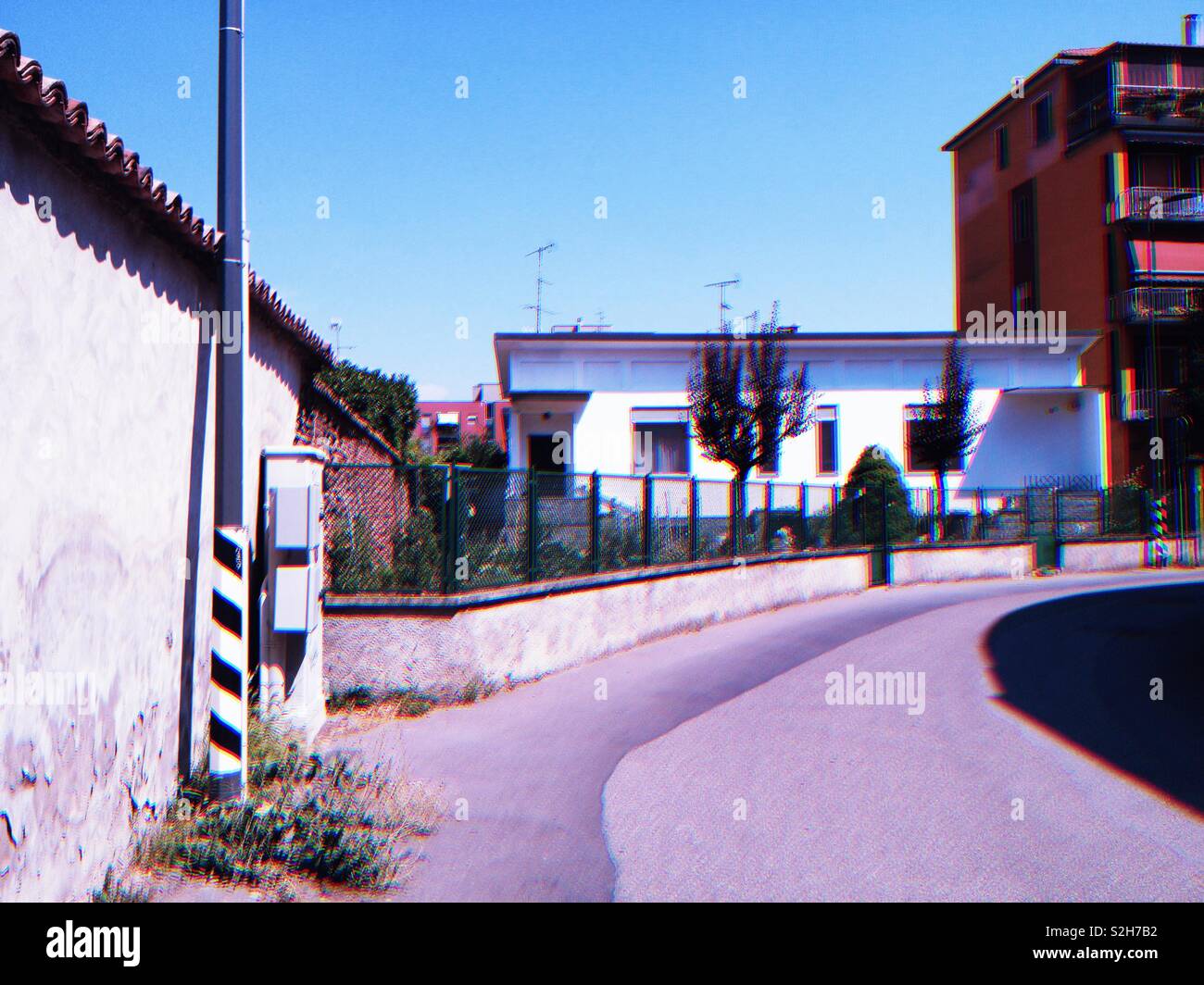 Street in Trenno, a neighborhood of Milano, Italia, in 2018, with a vintage film effect. - Smartphone Captured Stock Image