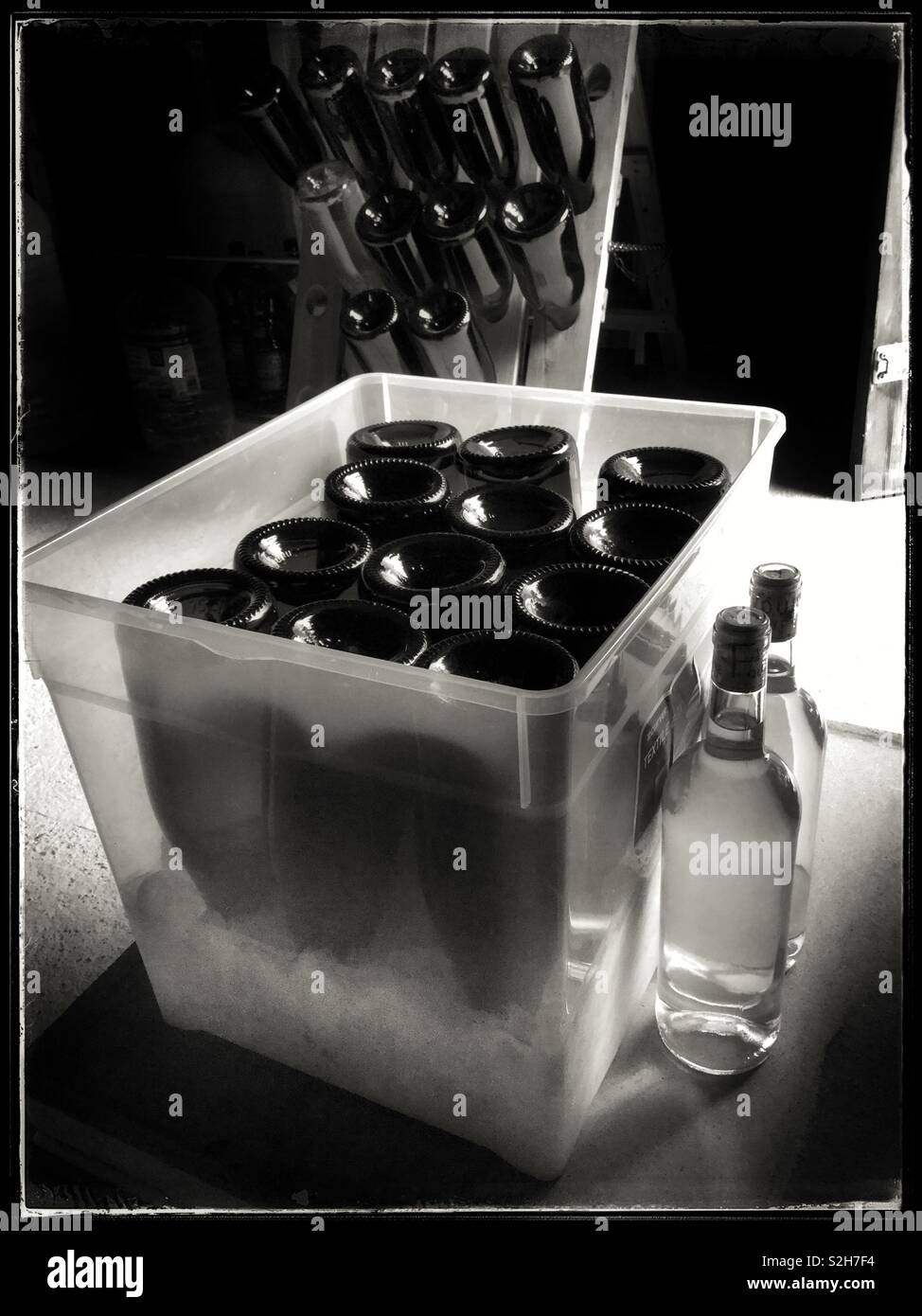 Freezing the necks of bottles of homemade sparkling wine ready for