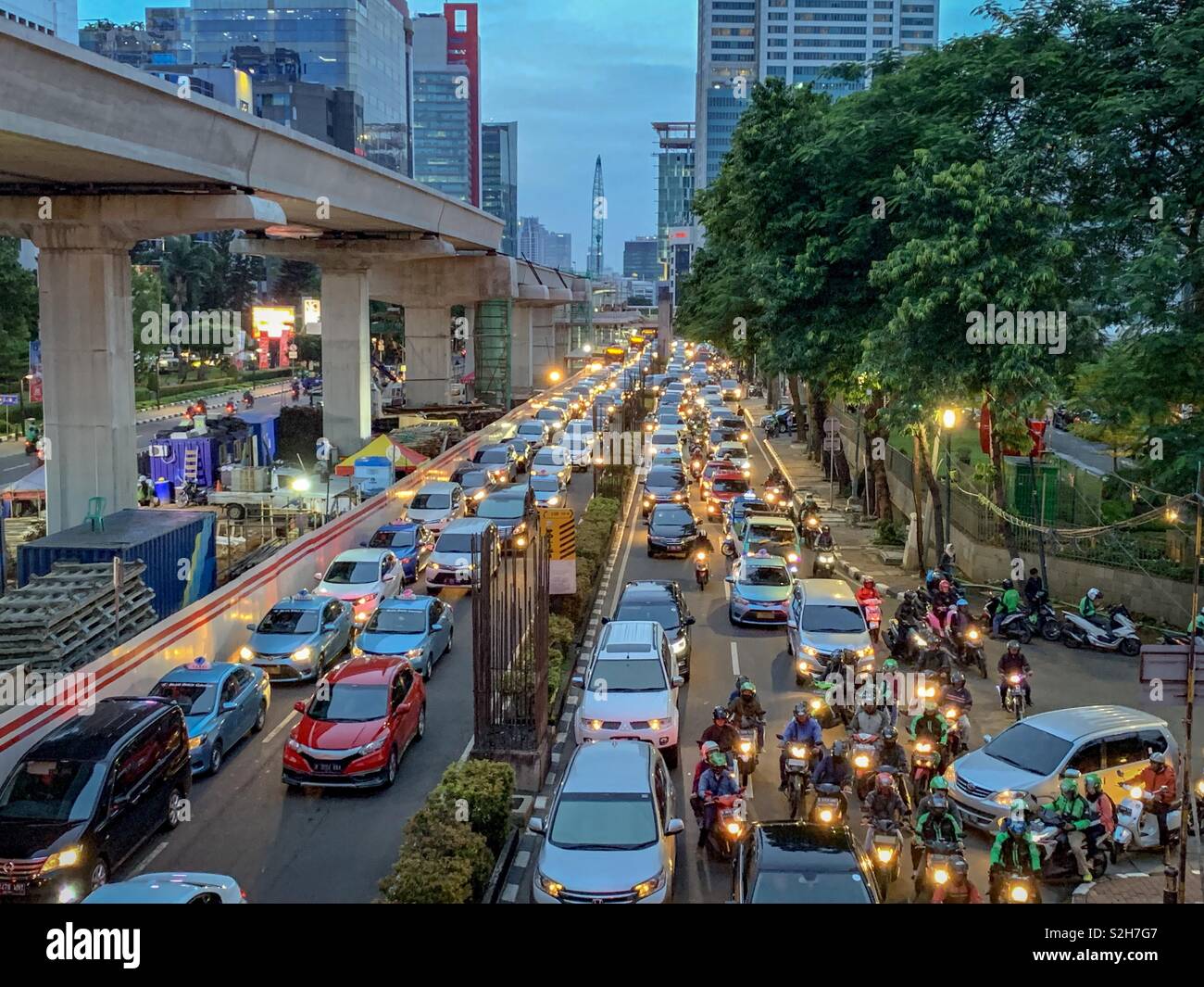 The daily grind of the Jakarta traffic. Battle for momentum strikes the cars and motorcycles. - Smartphone Captured Stock Image