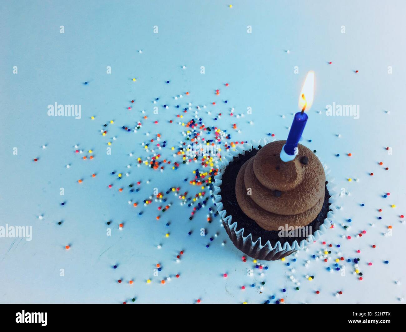 Cupcake with blue candle. Stock Photo