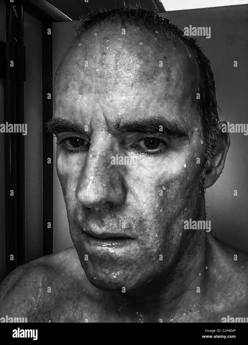 Self portrait in swimming pool changing room. Just out of the pool. Scotland. UK. Stock Photo