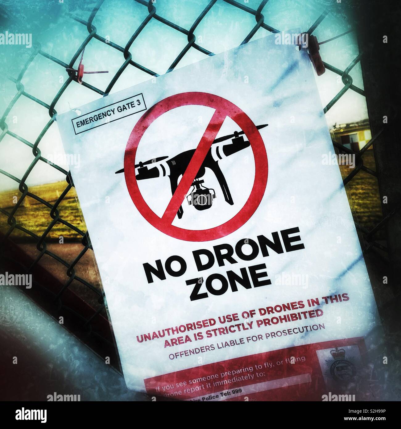 No Drone Zone warning sign on airport boundary fence in UK - Smartphone Captured Stock Image