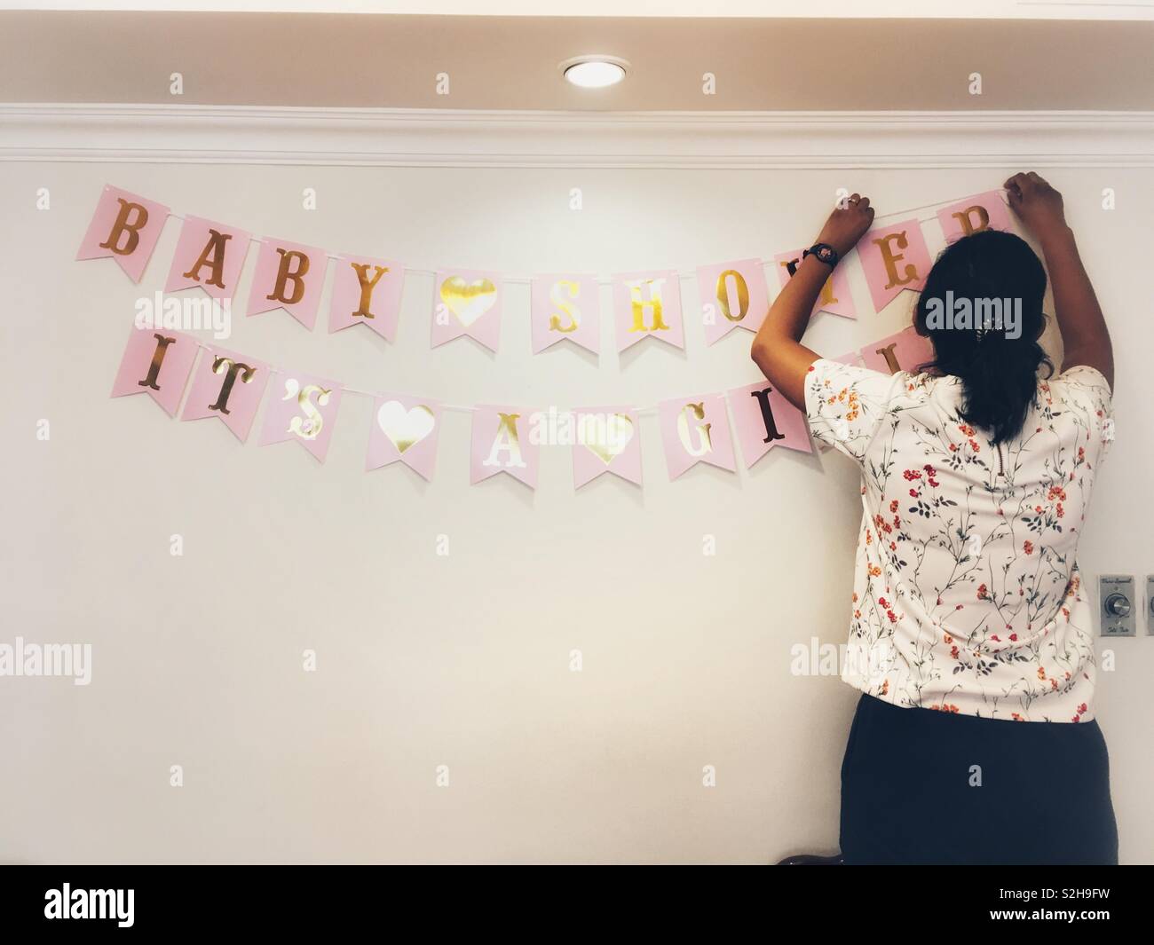 A woman decorating room for a Baby Shower Stock Photo