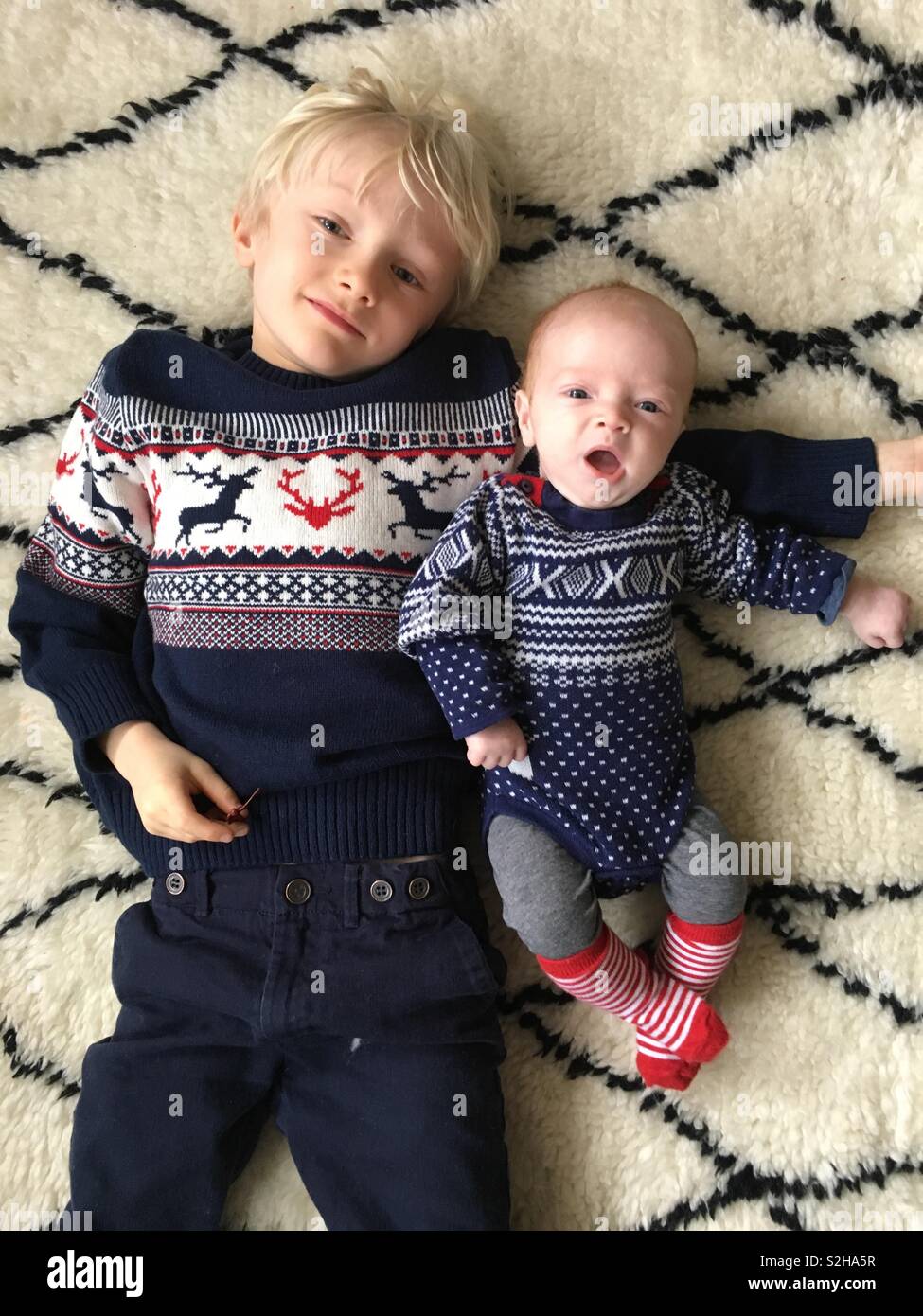Brothers in Christmas jumpers Stock Photo