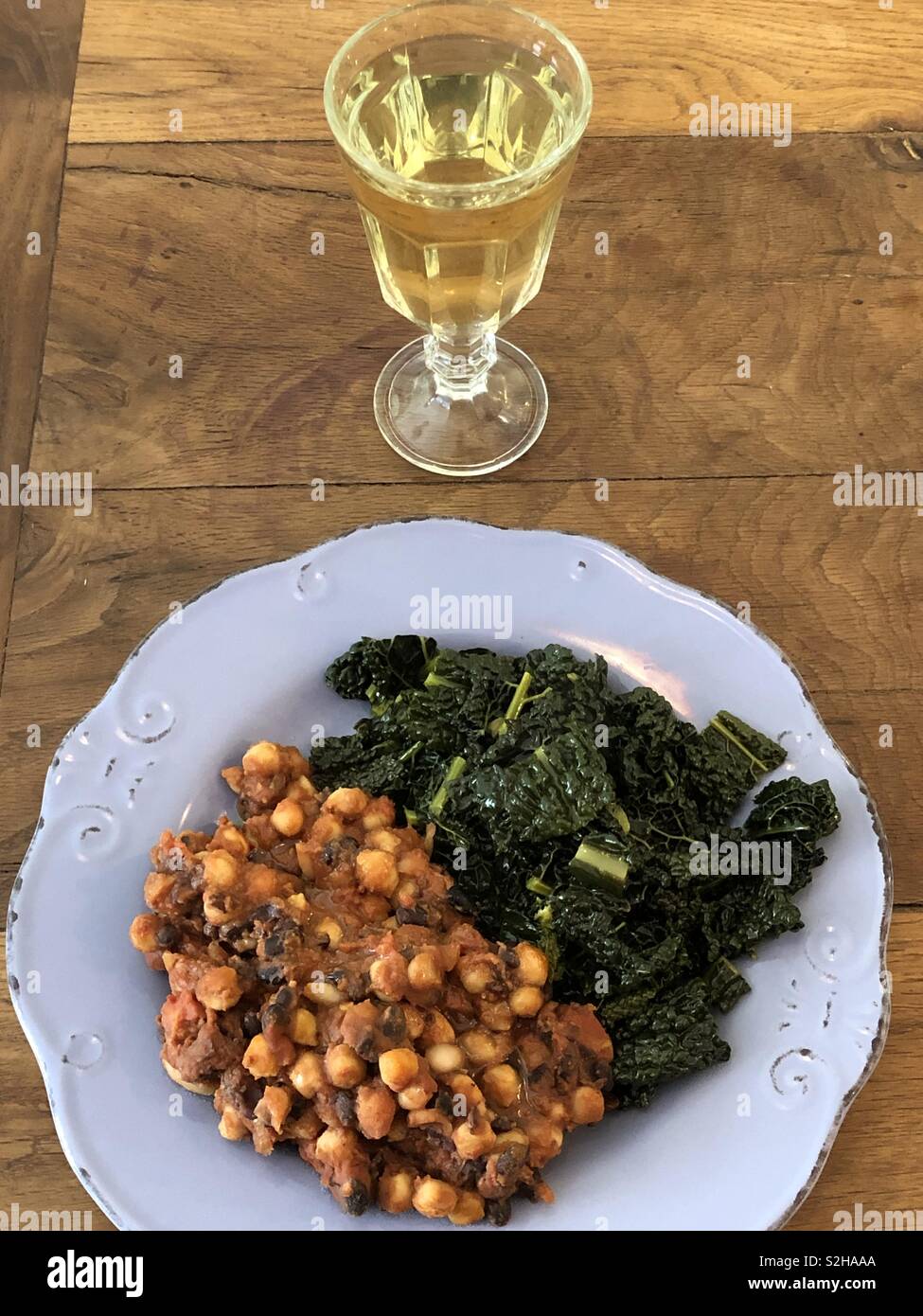 Healthy lunch with an organic glass of white wine and a dish of vegetables Stock Photo