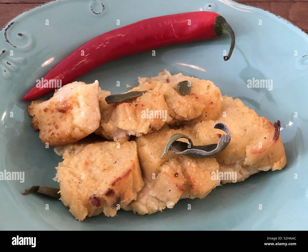 Gnocchi cake with a red chili pepper Stock Photo